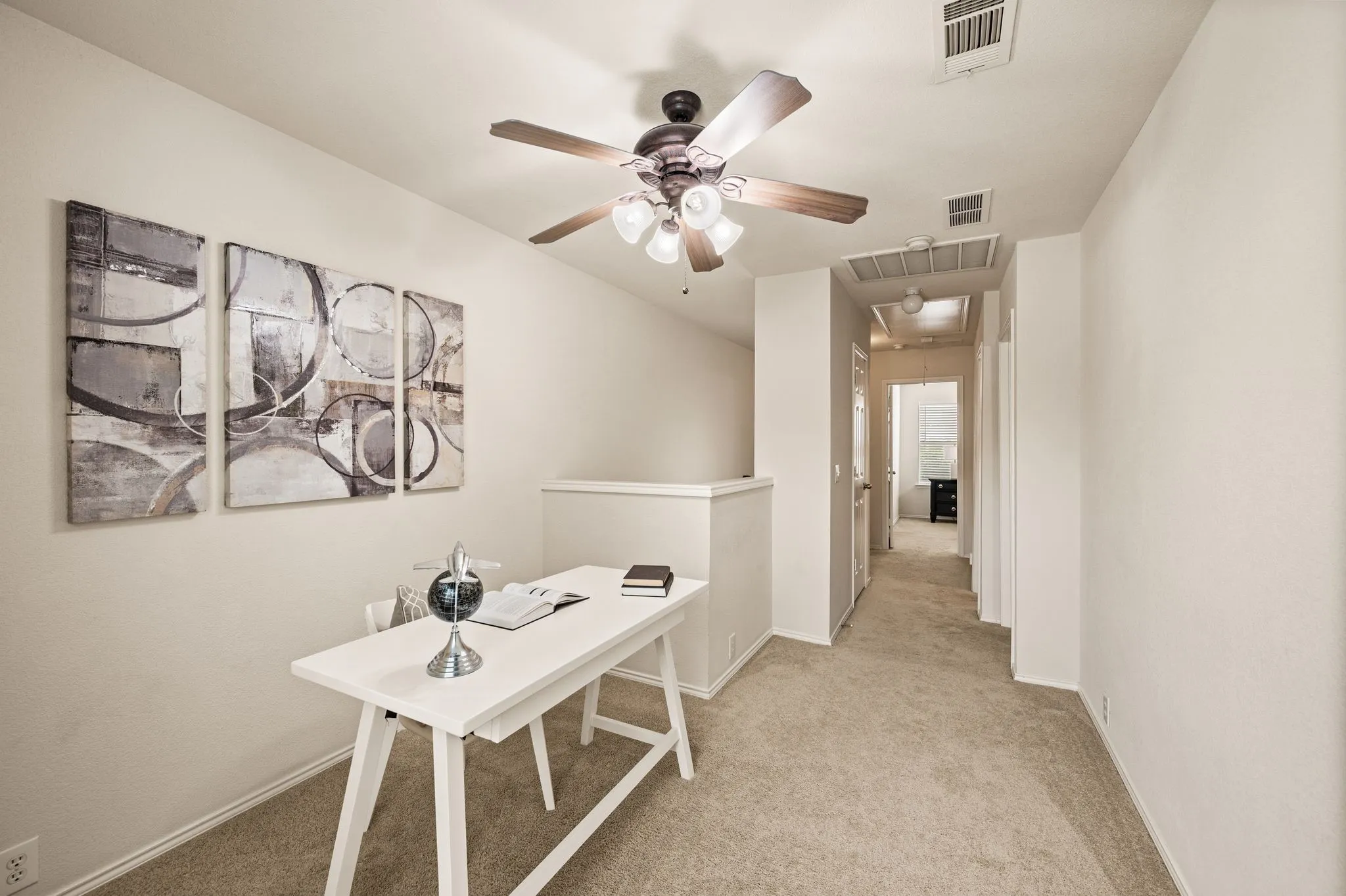 Carpeted flooring, vaulted ceiling, ceiling fan with integrated lighting, wall-to-wall carpeting, open-concept hallway