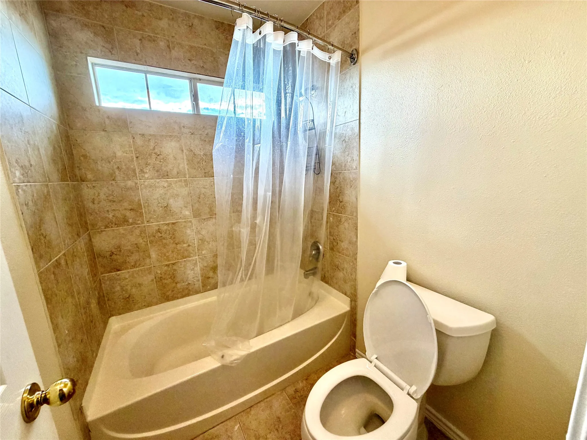 Bathtub with integrated shower and tile surround