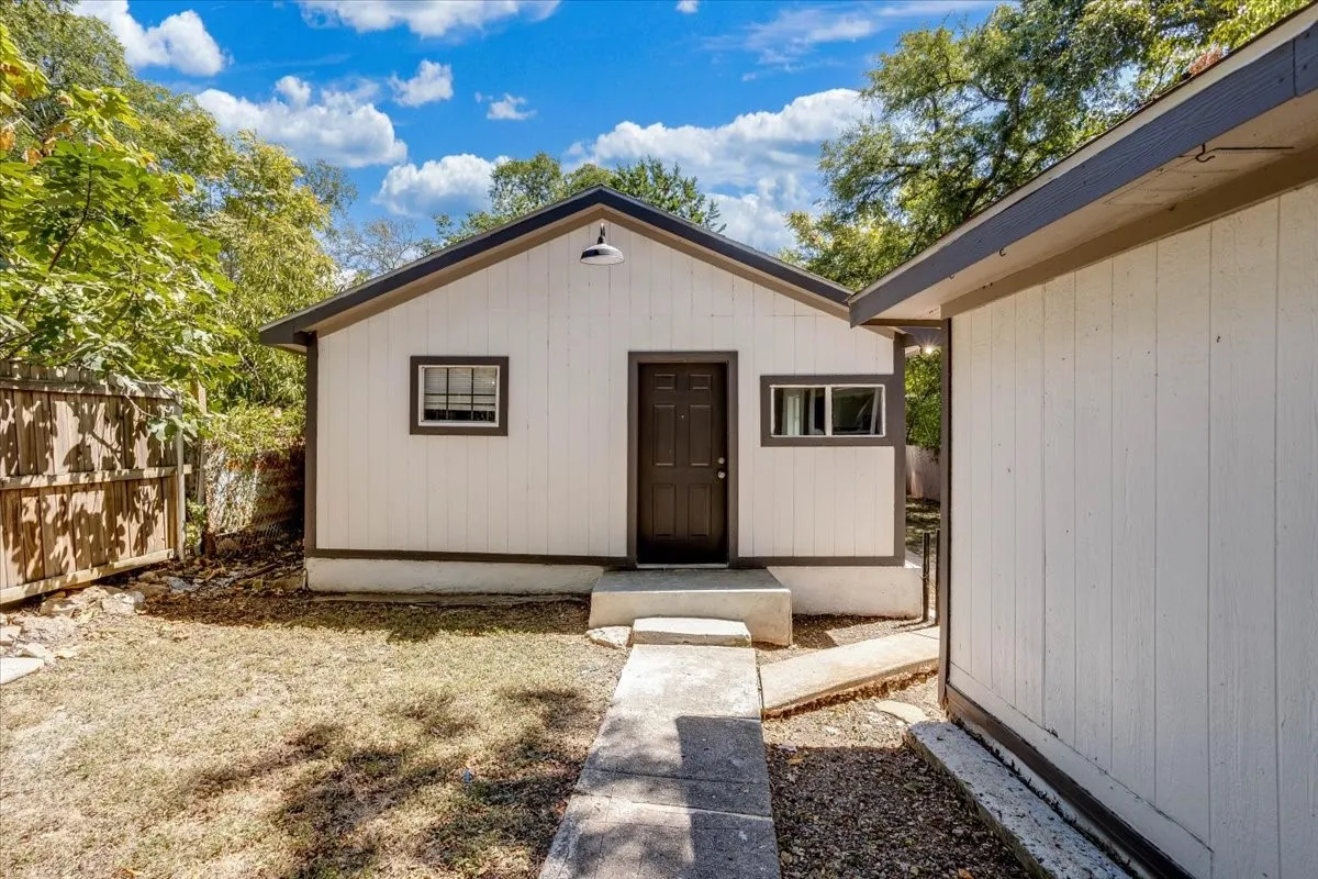 White vertical siding exterior with dark trim