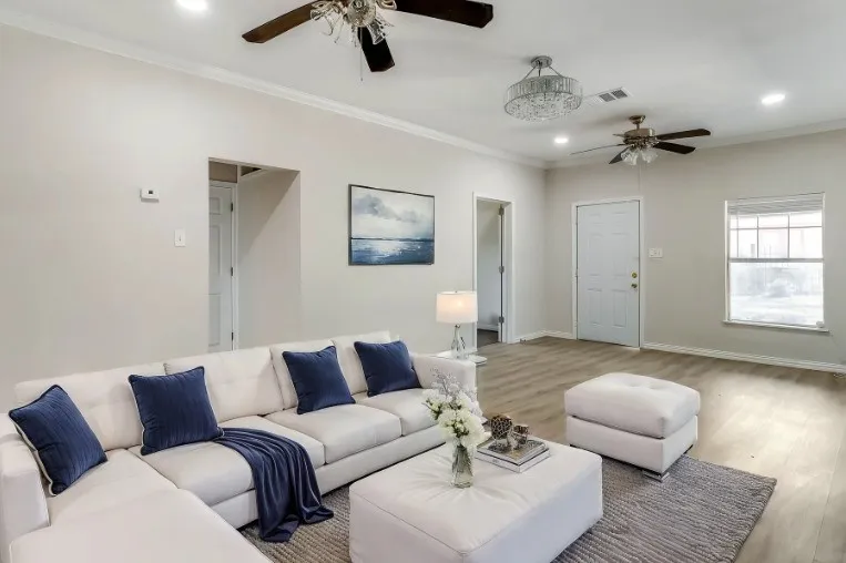 Recessed lighting, crown molding, wood-finish flooring, a contemporary chandelier, and ceiling fans *Virtually staged