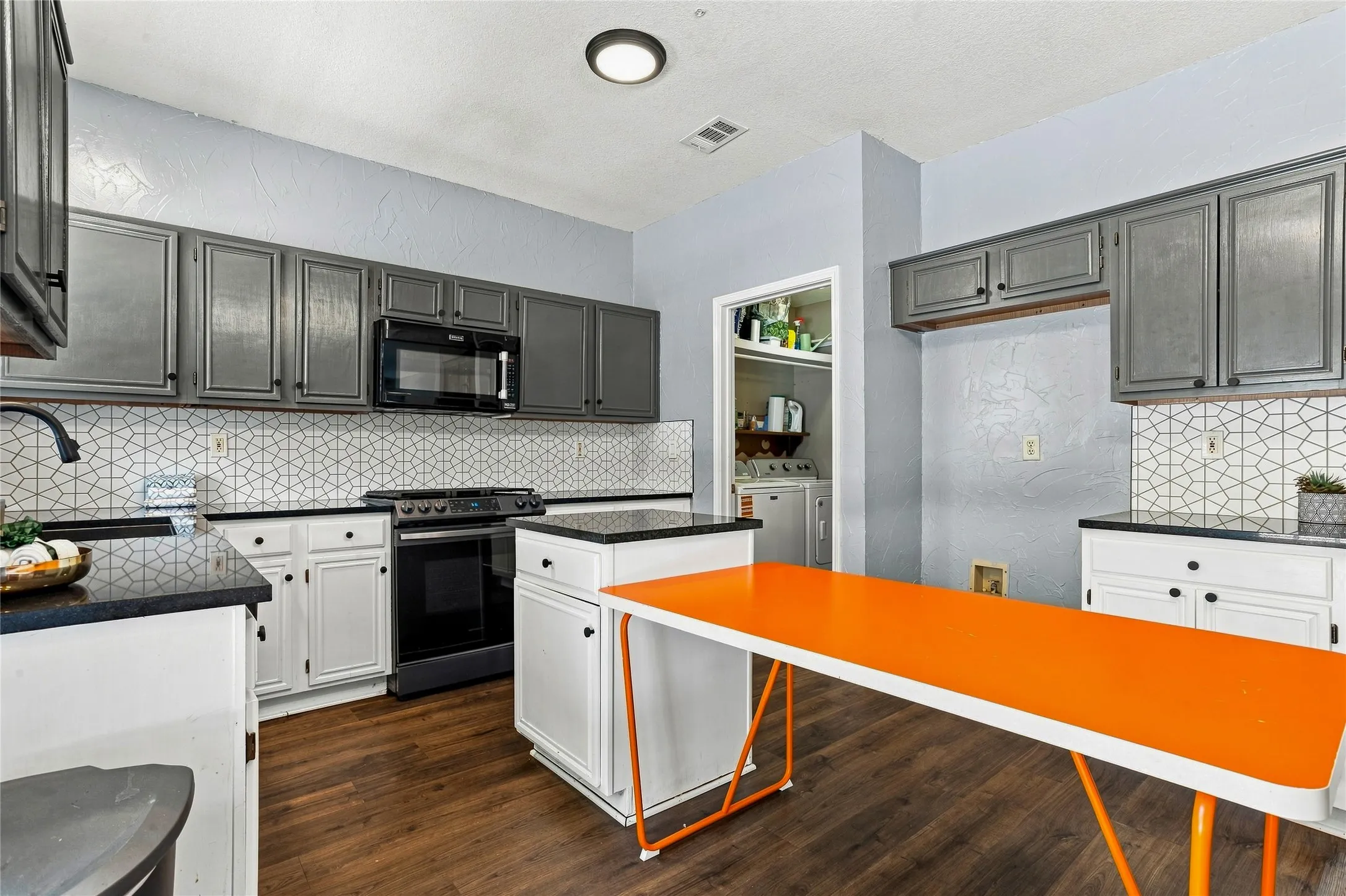 On the back of the home, the family room has easy access to upstairs or the kitchen-Virtually Staged Photo