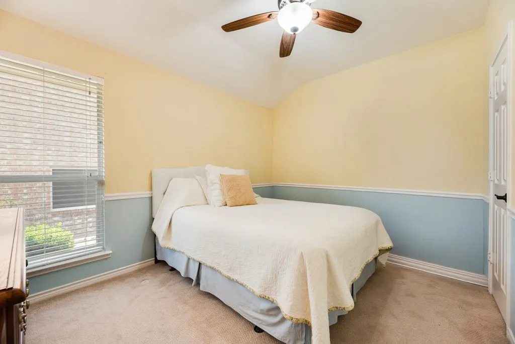 Bedroom 4, Vaulted ceiling, ceiling fan with light fixture, carpeted flooring, window with blinds, two-tone wall treatment