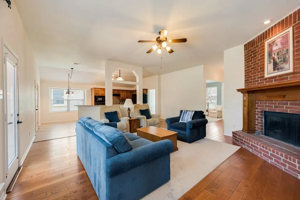 Brick fireplace with a wood mantel