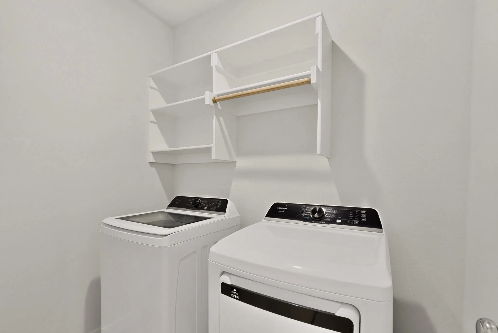 Laundry appliances with an overhead shelving unit and hanging rod