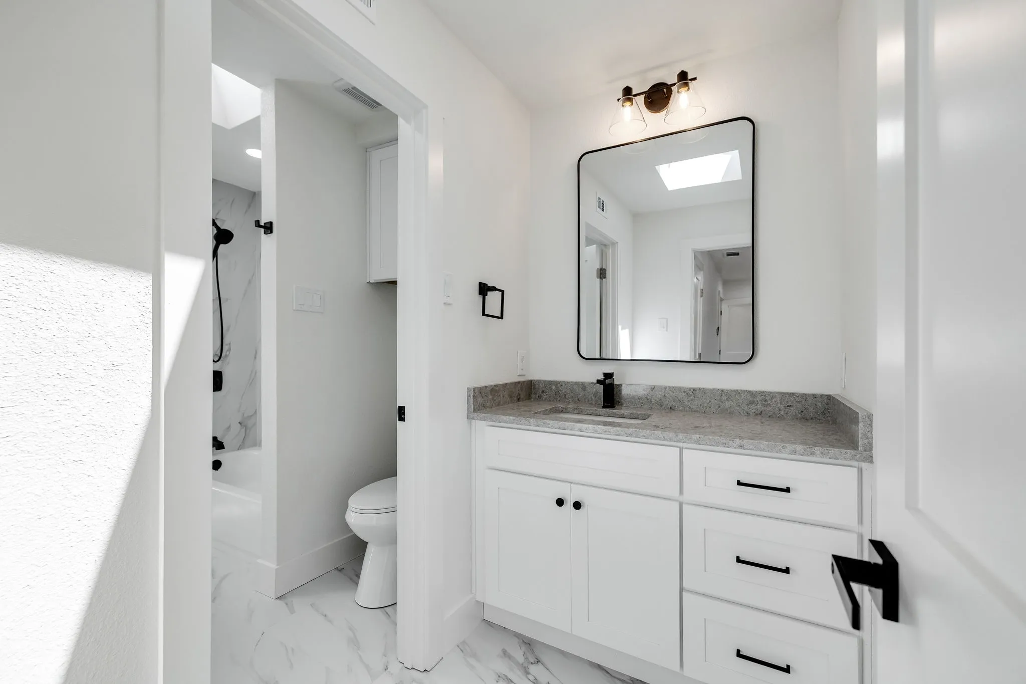 4402 Briargrove-White vanity with a stone-finish countertop and undermount sink