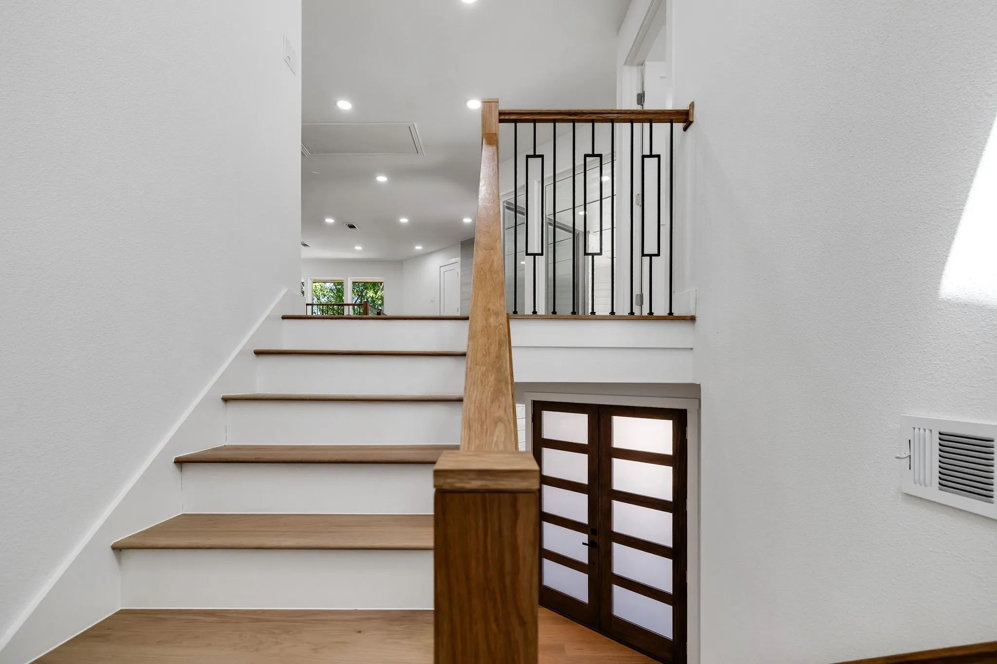 4402 Briargrove-Hardwood stair treads with white risers and a wood handrail