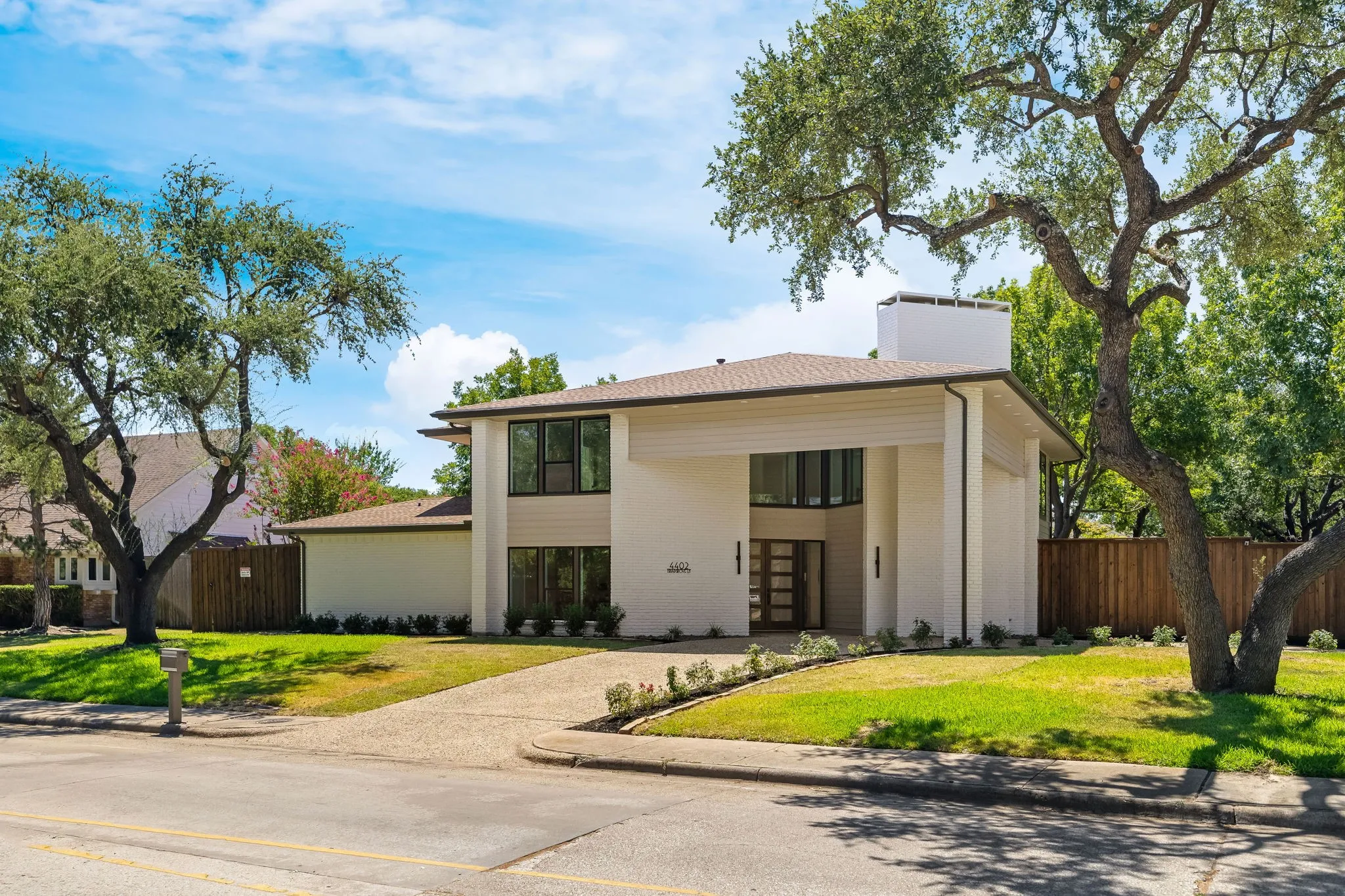 4402 Briargrove- ight-toned brick exterior complemented by warm horizontal wood-finish siding accents.