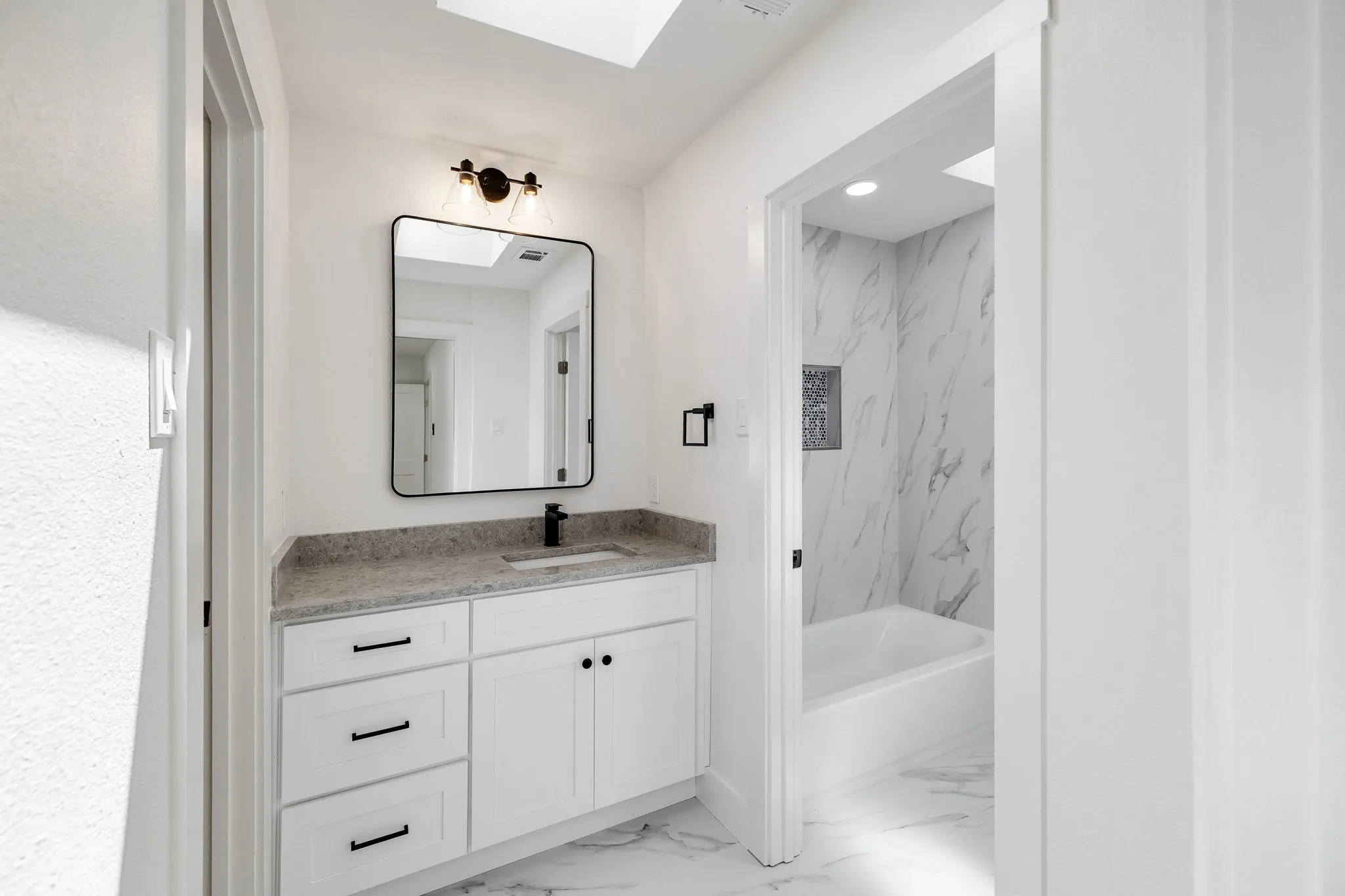 4402 Briargrove-White vanity with a light-toned countertop, rectangular sink, and matte black fixtures