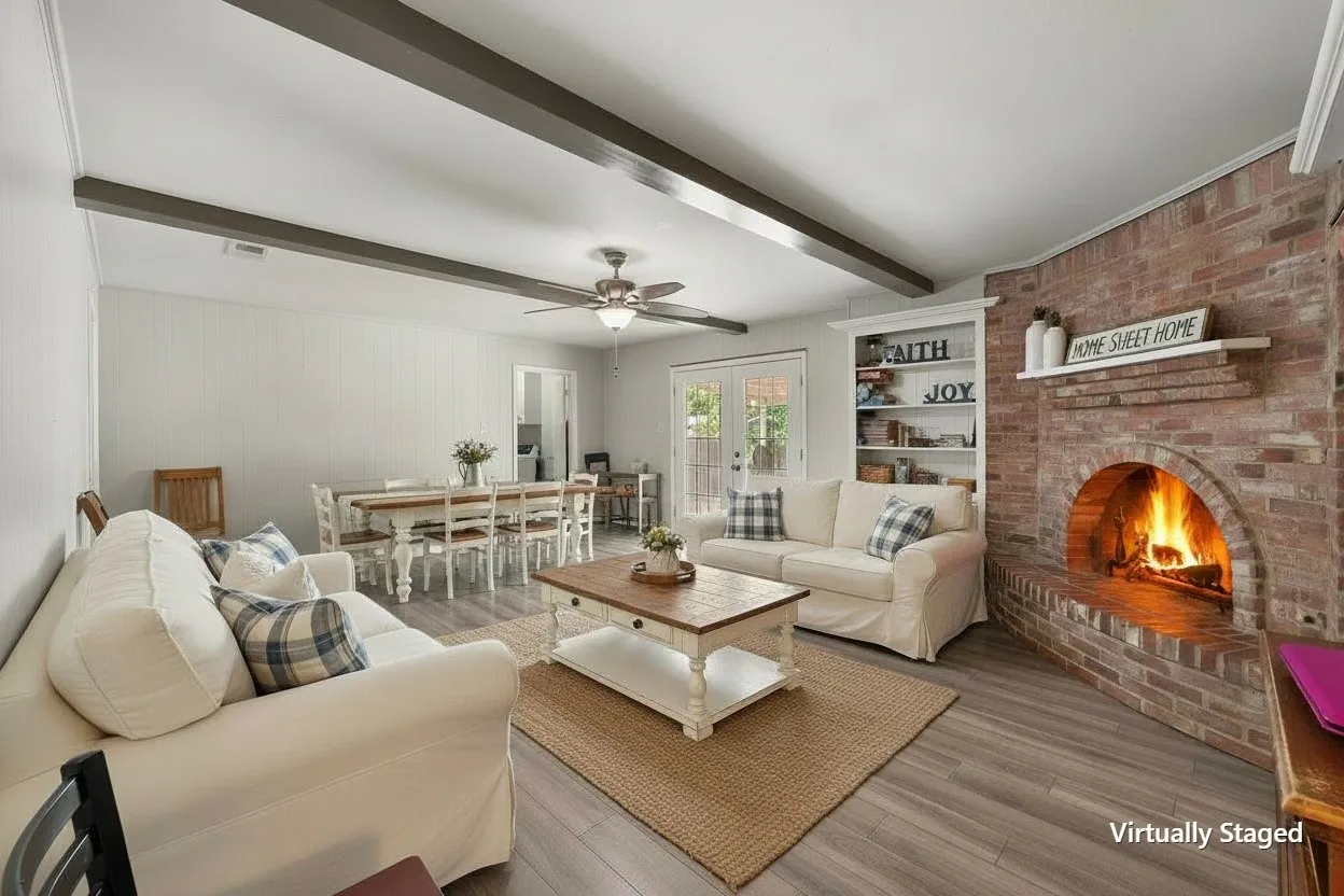 Virtually staged living room illustrates the potential of the spacious main gathering area surrounding the home's brick fireplace.