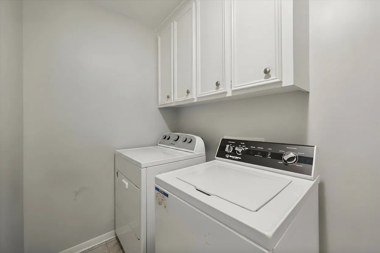 Dedicated utility room provides full-size laundry connections and built-in cabinetry, an important everyday convenience for a rental property.