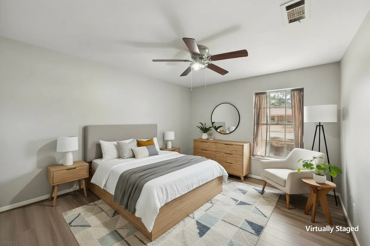Virtually staged secondary bedroom demonstrates an inviting furniture arrangement while showcasing the room's usable floor space.
