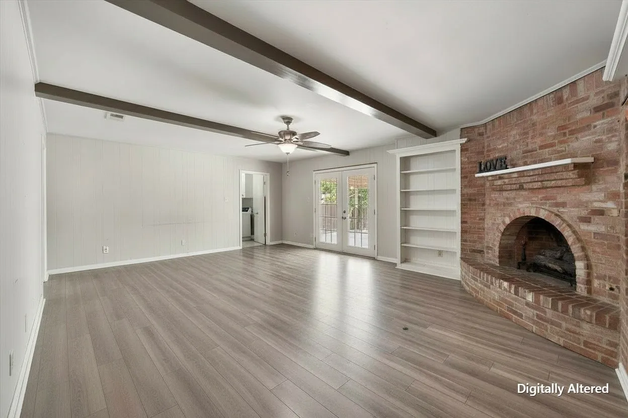 Alternate living-room angle highlights the fireplace wall, open floor plan, ceiling fan, and easy connection to the rest of the home.