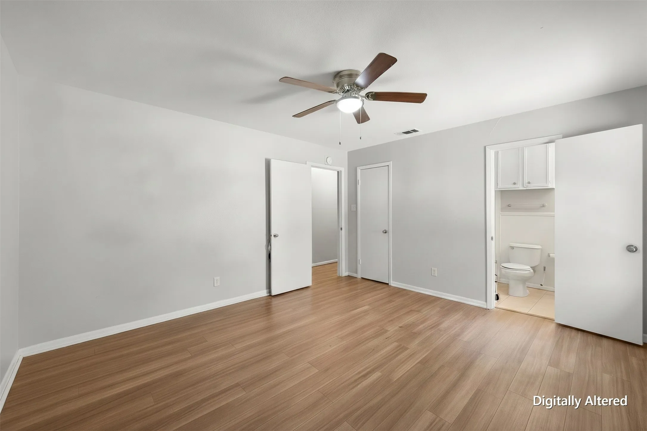 Empty primary bedroom view highlights the generous floor area and neutral finishes, making the room easy  to personalize.