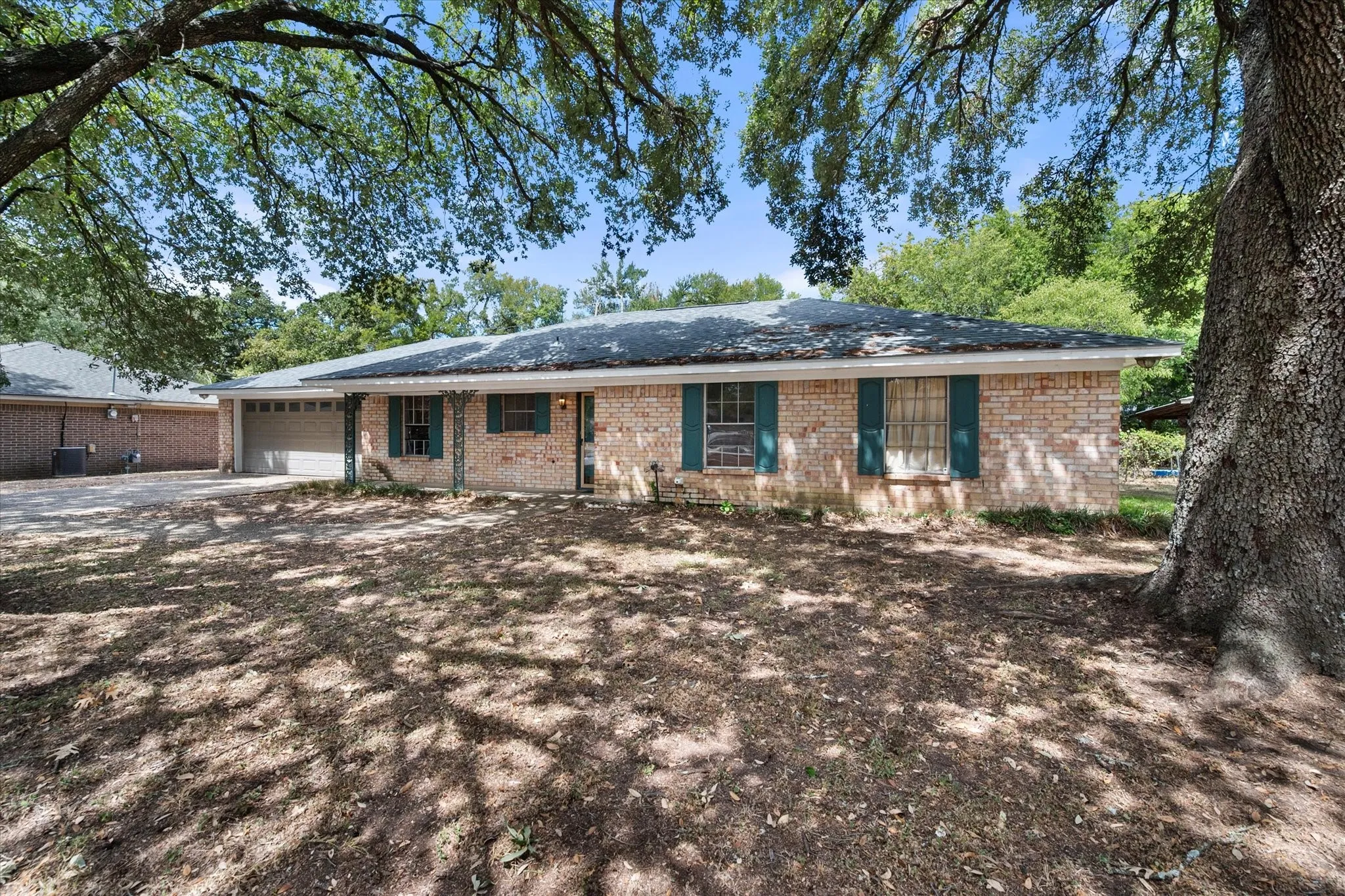 Mature trees create abundant shade and curb appeal across the front of this tenant-occupied investment property in Corsicana, Texas.