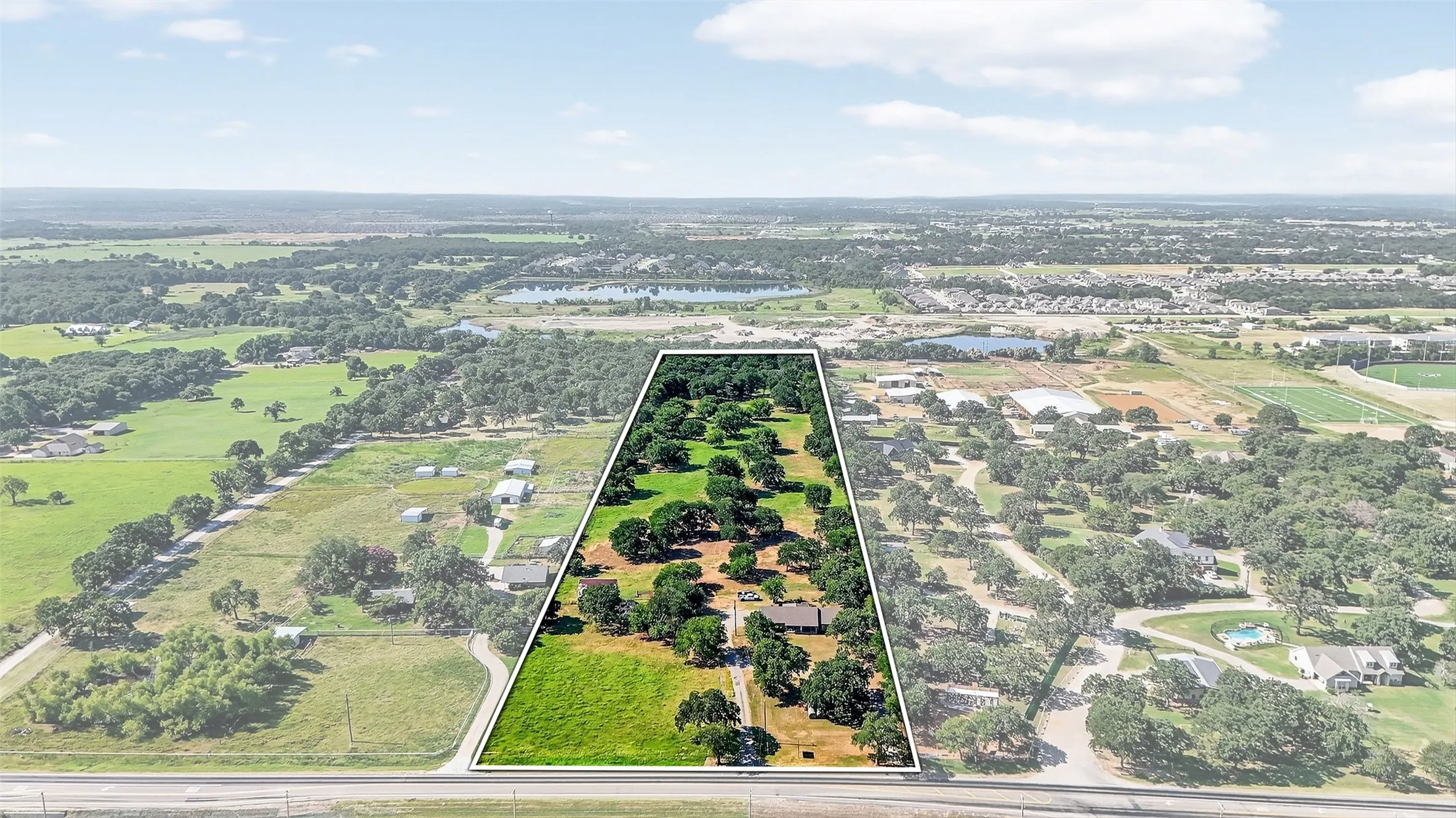 Expansive acreage with mature trees and open green spaces