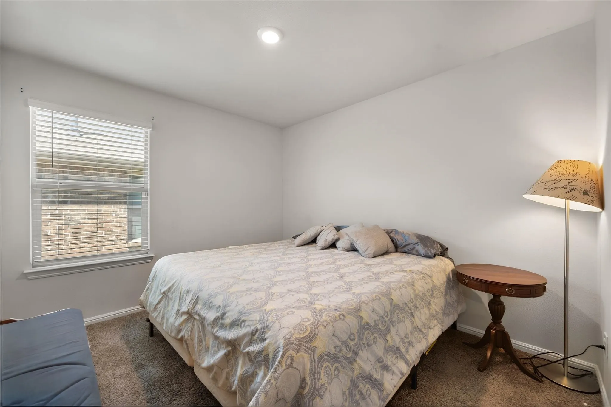 Recessed ceiling lighting, window with blinds, and carpeted flooring