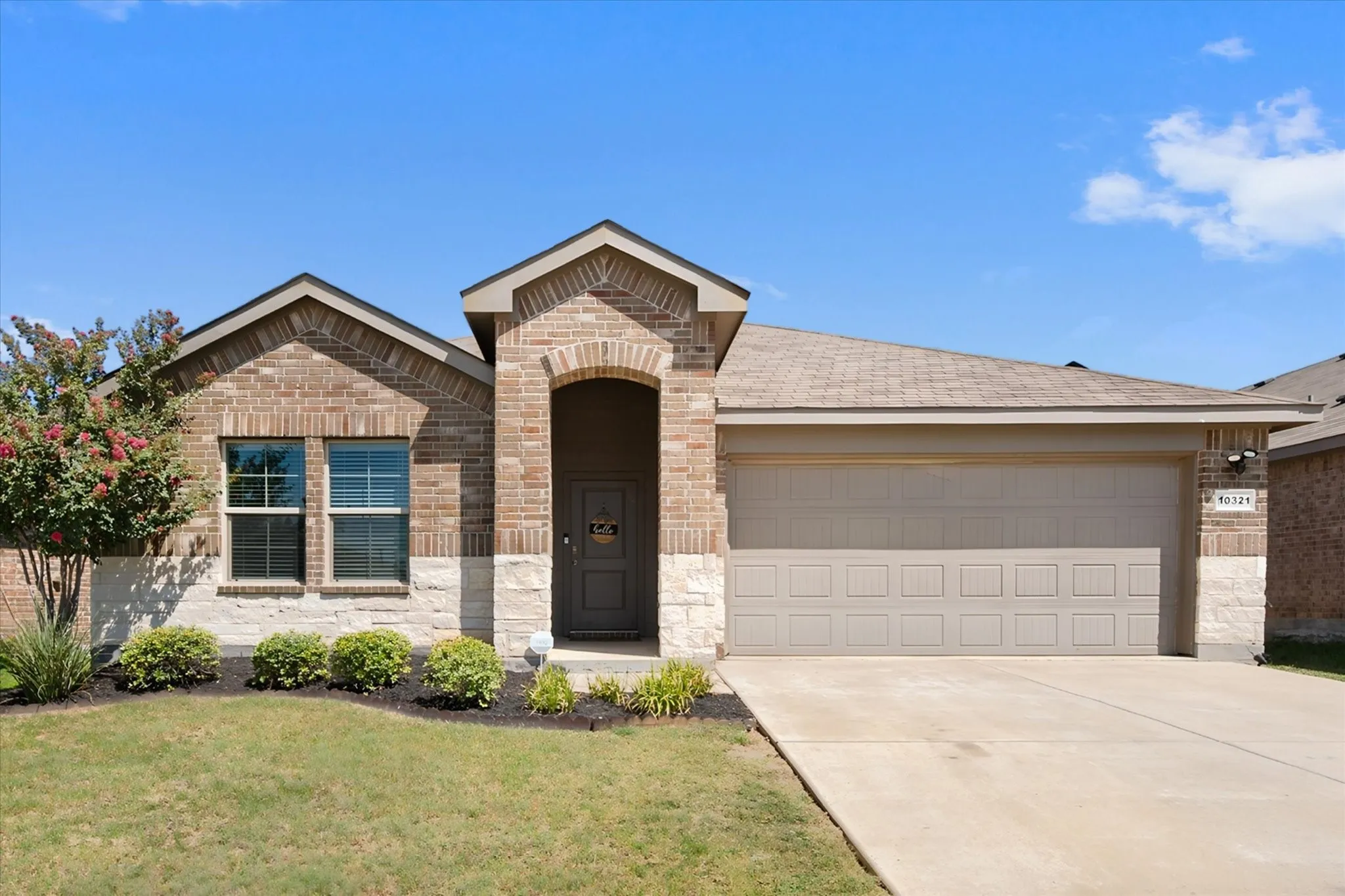 Brick and stone exterior with an arched entry