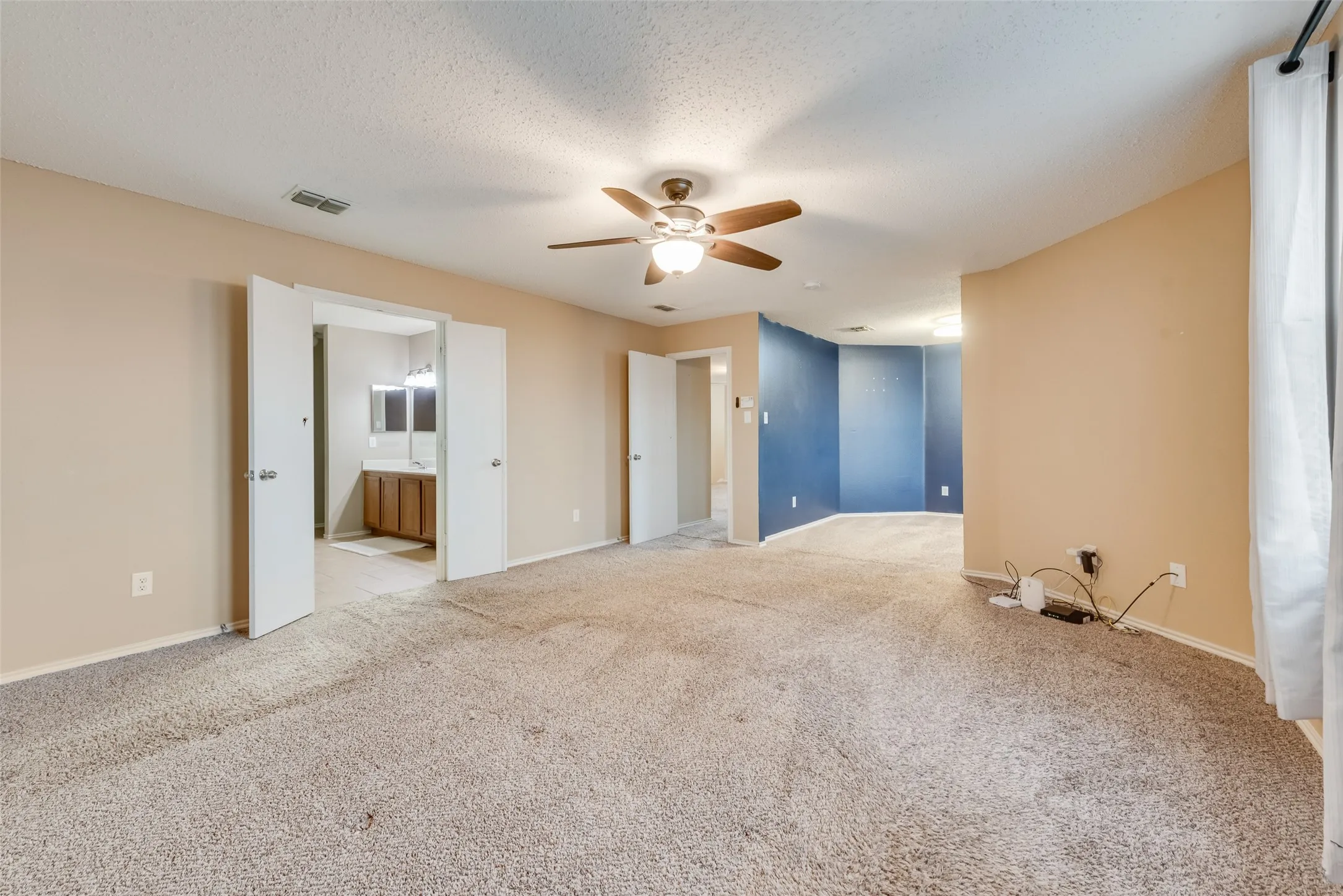 Another view of primary bedroom without staging