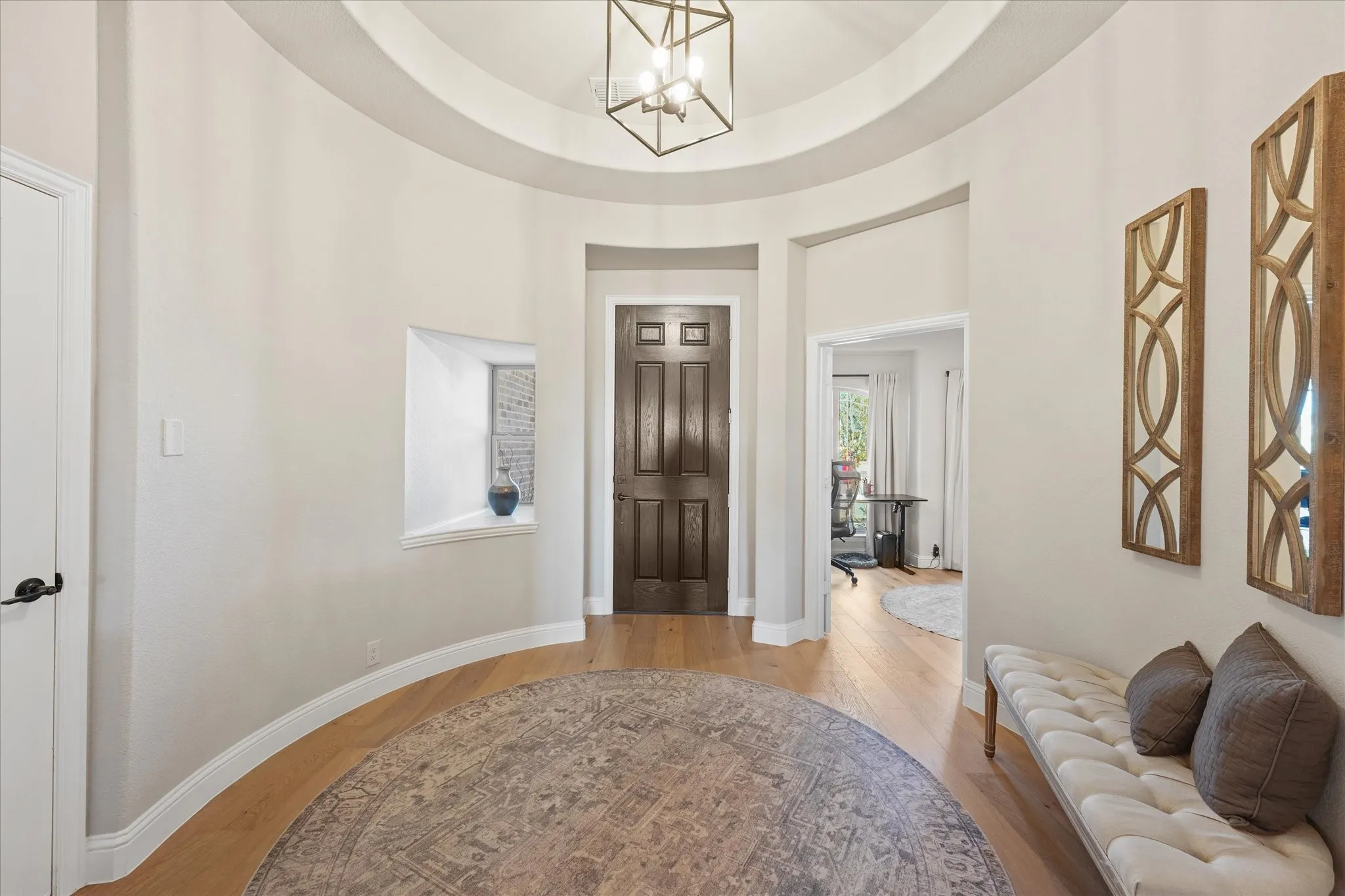Spacious entry showcases engineered hardwood floors, tall ceilings, neutral finishes, and an open sightline through the main living areas of this approximately 3,079-square-foot home.