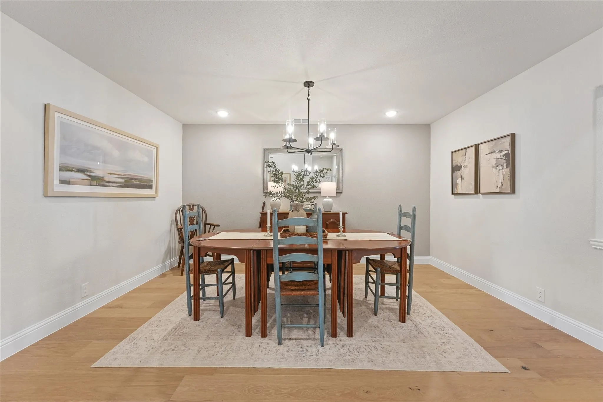 Large formal dining room with engineered hardwood flooring, neutral finishes, recessed lighting, and space for an oversized dining table—additional flexible living space for entertaining or everyday use.