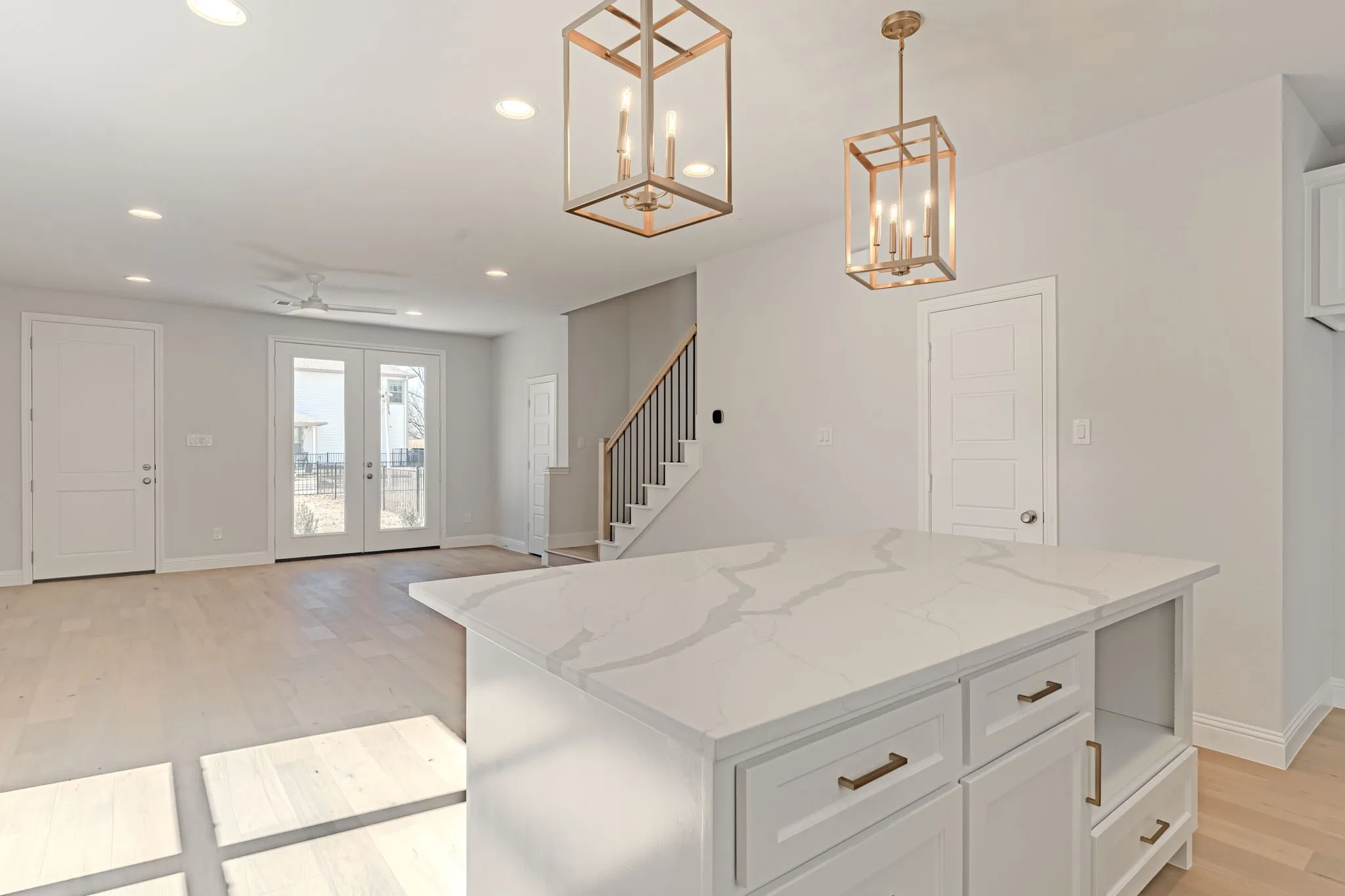 Living and dining open to kitchen with large island and gas cooking