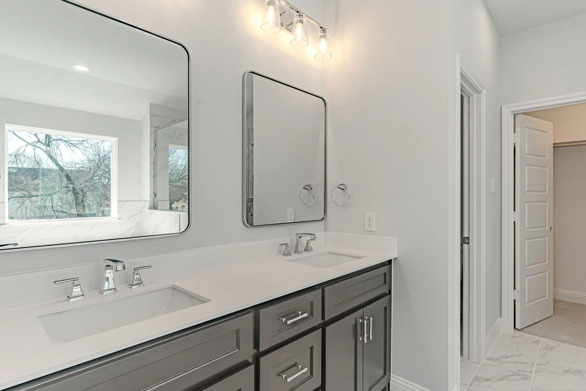 Double vanity owner's suite with separate shower and toilet areas