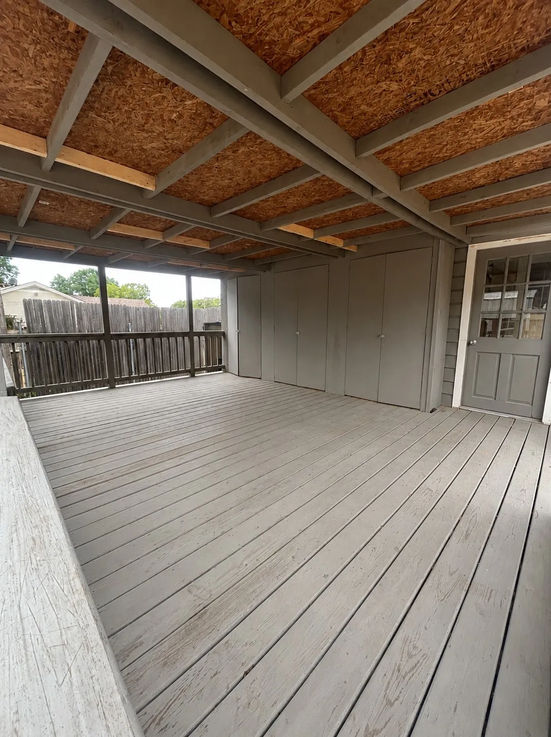 Large covered back deck with additional storage.