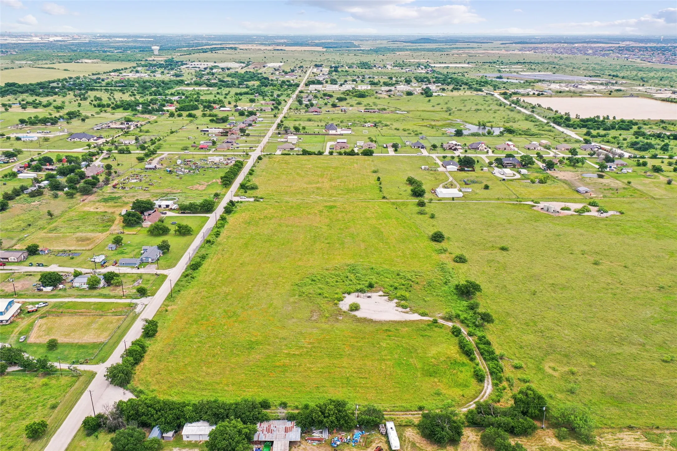 Expansive verdant landscape with scattered residential properties