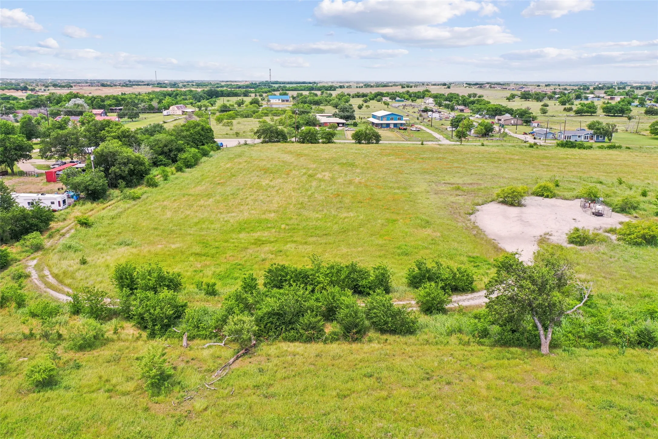 Expansive acreage featuring established trees and a natural elevation change