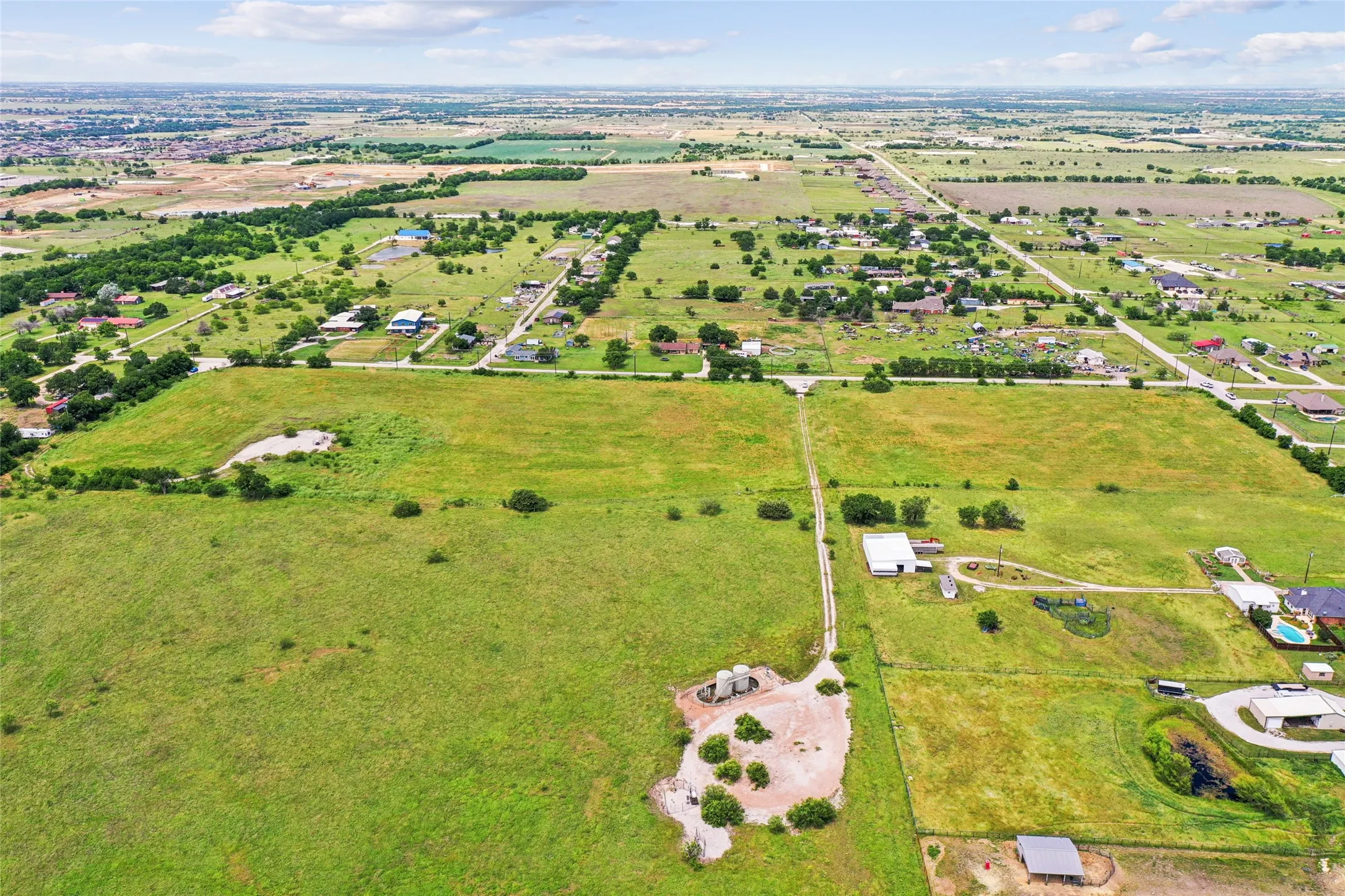Expansive green acreage with scattered trees