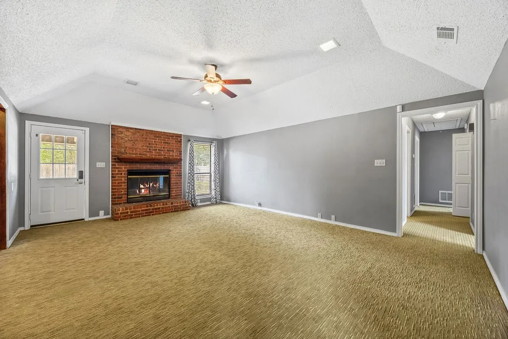 Open Living Space with Wood Burning Fireplace as the Centerpiece