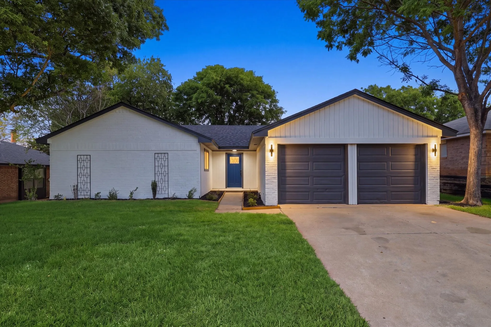White brick exterior with a dark blue entry door