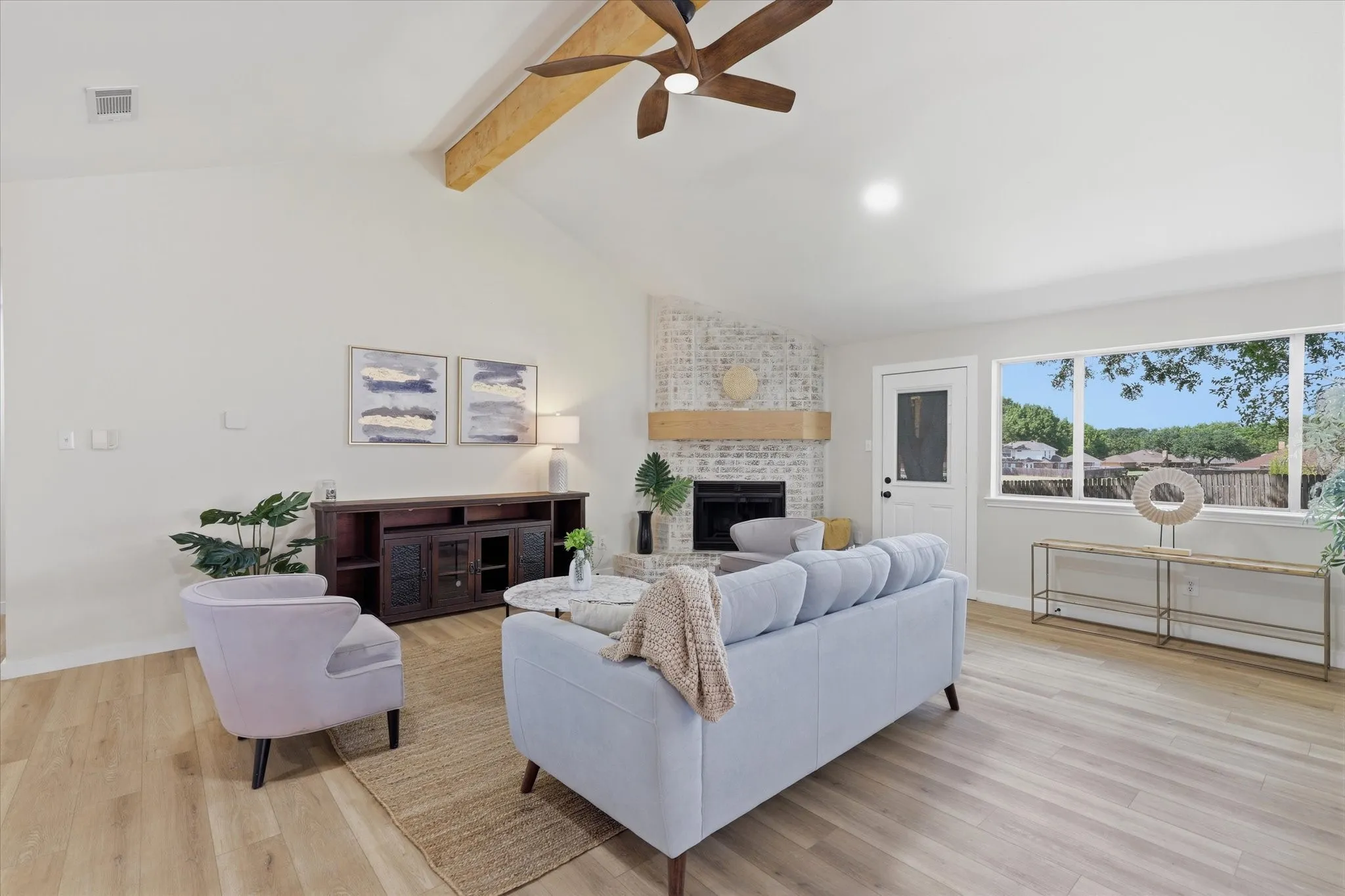 Vaulted ceiling with wood-finish beam and ceiling fan
