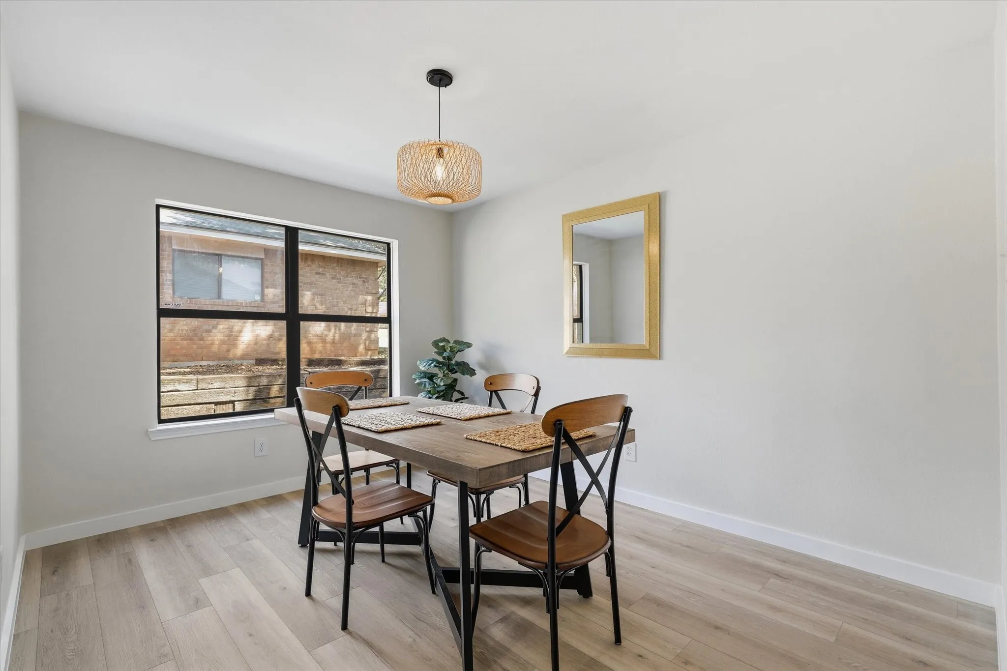 Recessed lighting, light wood-finish flooring, and a contemporary pendant light fixture