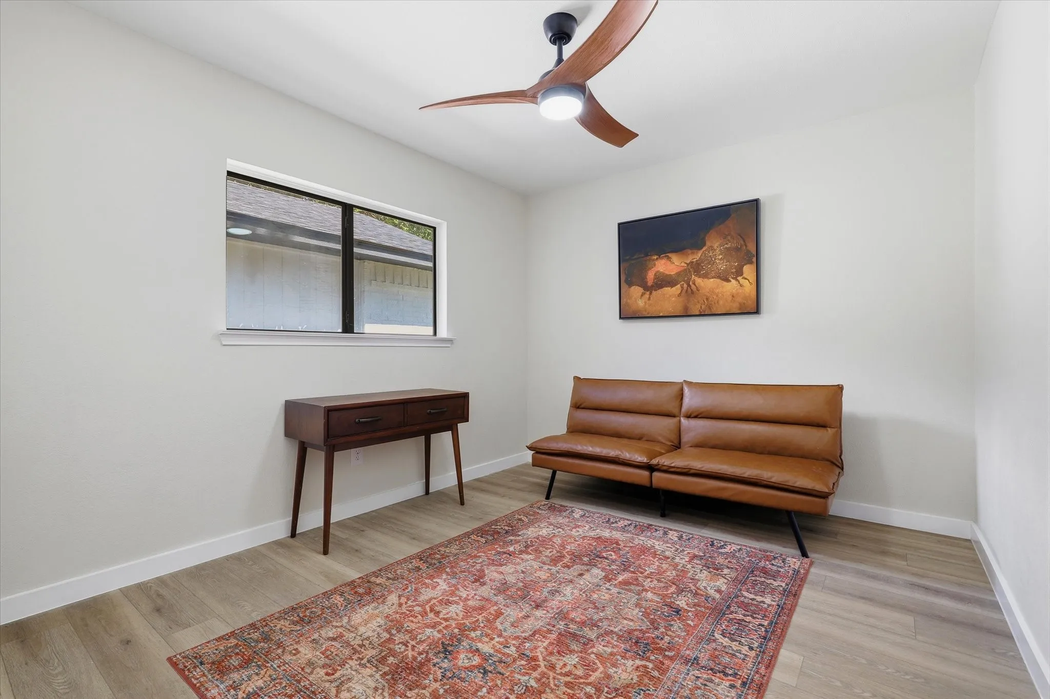 Recessed lighting, wood-finish flooring, and a modern ceiling fan with integrated lighting