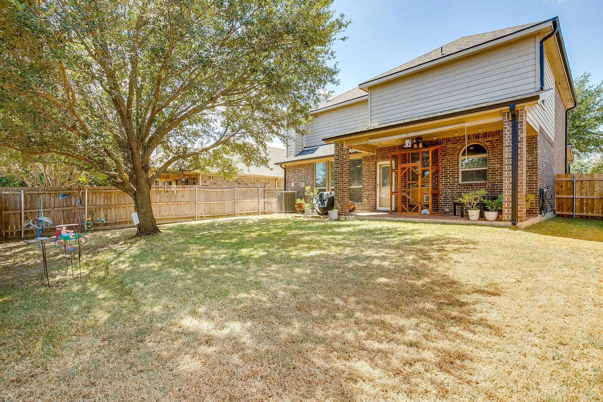 Wonderful backyard with large covered patio and roller shades for the hot summer days.
