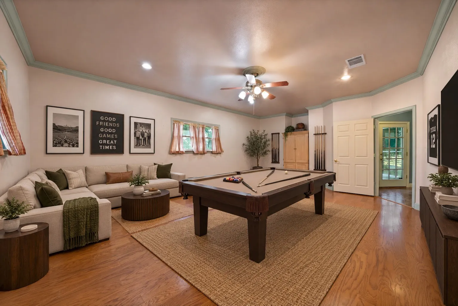 Photo has been virtually staged. Hardwood flooring, recessed lighting, ceiling fan, crown molding, and a paneled door