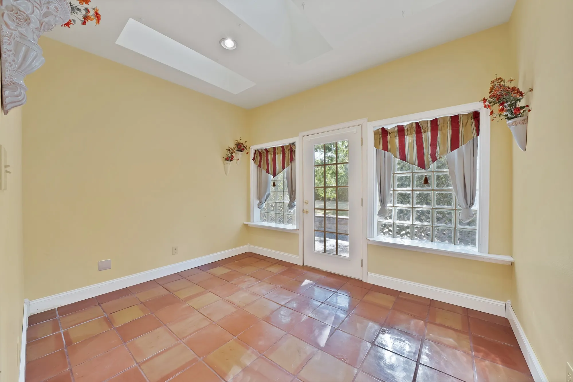 Terra cotta tile flooring, with skylights that open, and glass block windows