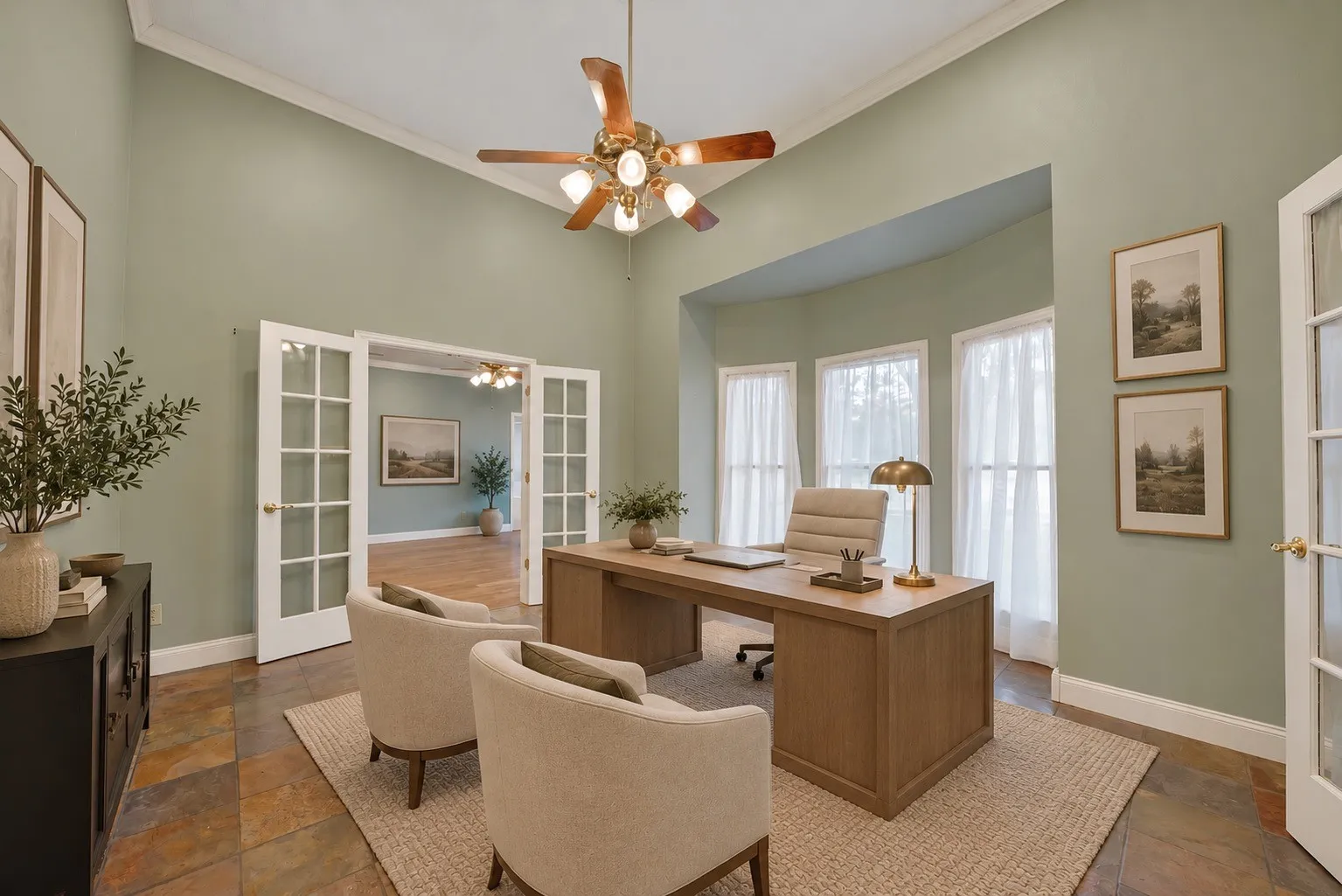 Photo has been virtually staged. French doors leading to an additional room, bay window with three vertical windows, vaulted ceiling, multi-color slate flooring, and a ceiling fan with wood-finish blades