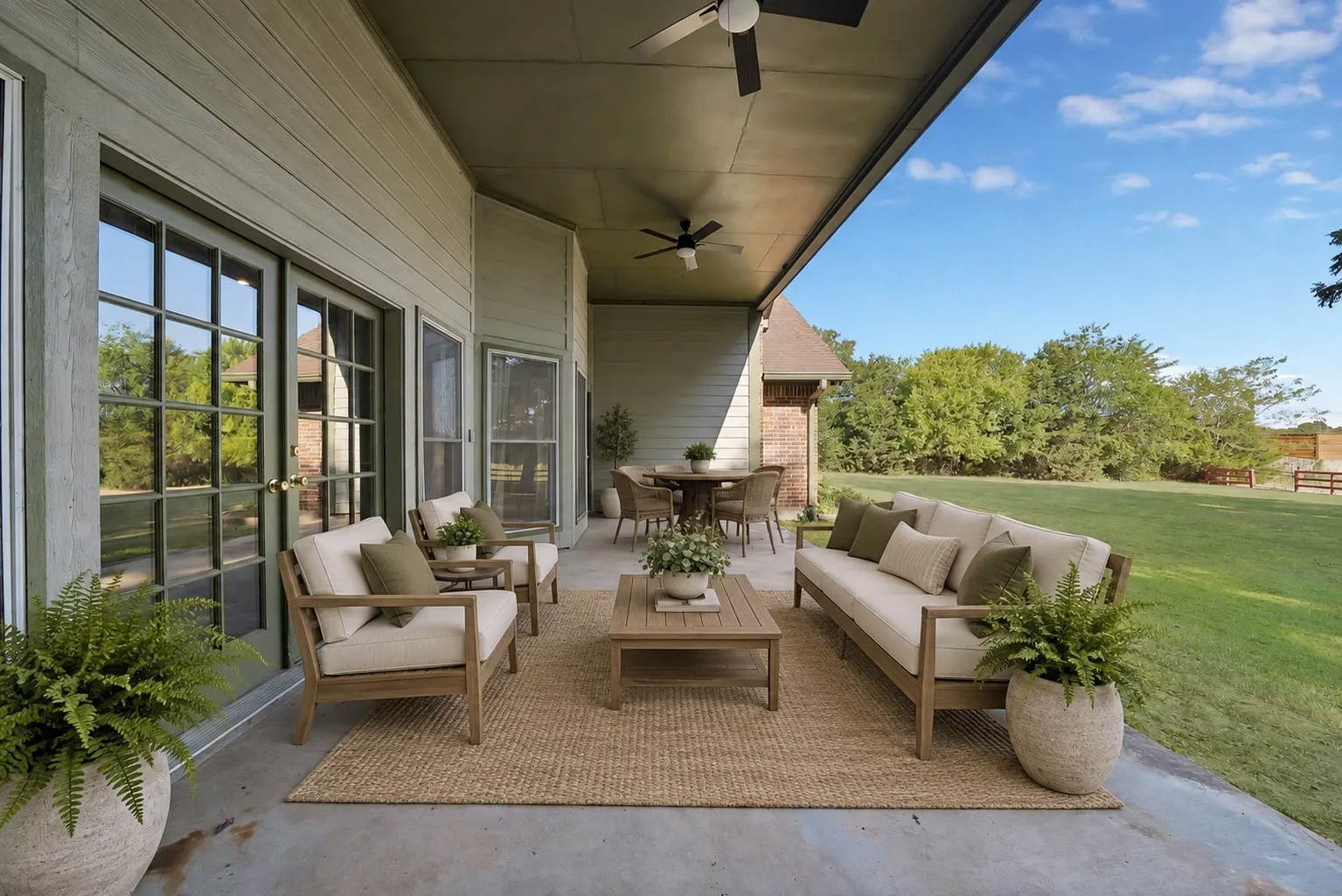 Photo has been virtually staged. Expansive covered patio featuring a concrete surface and a woven rug