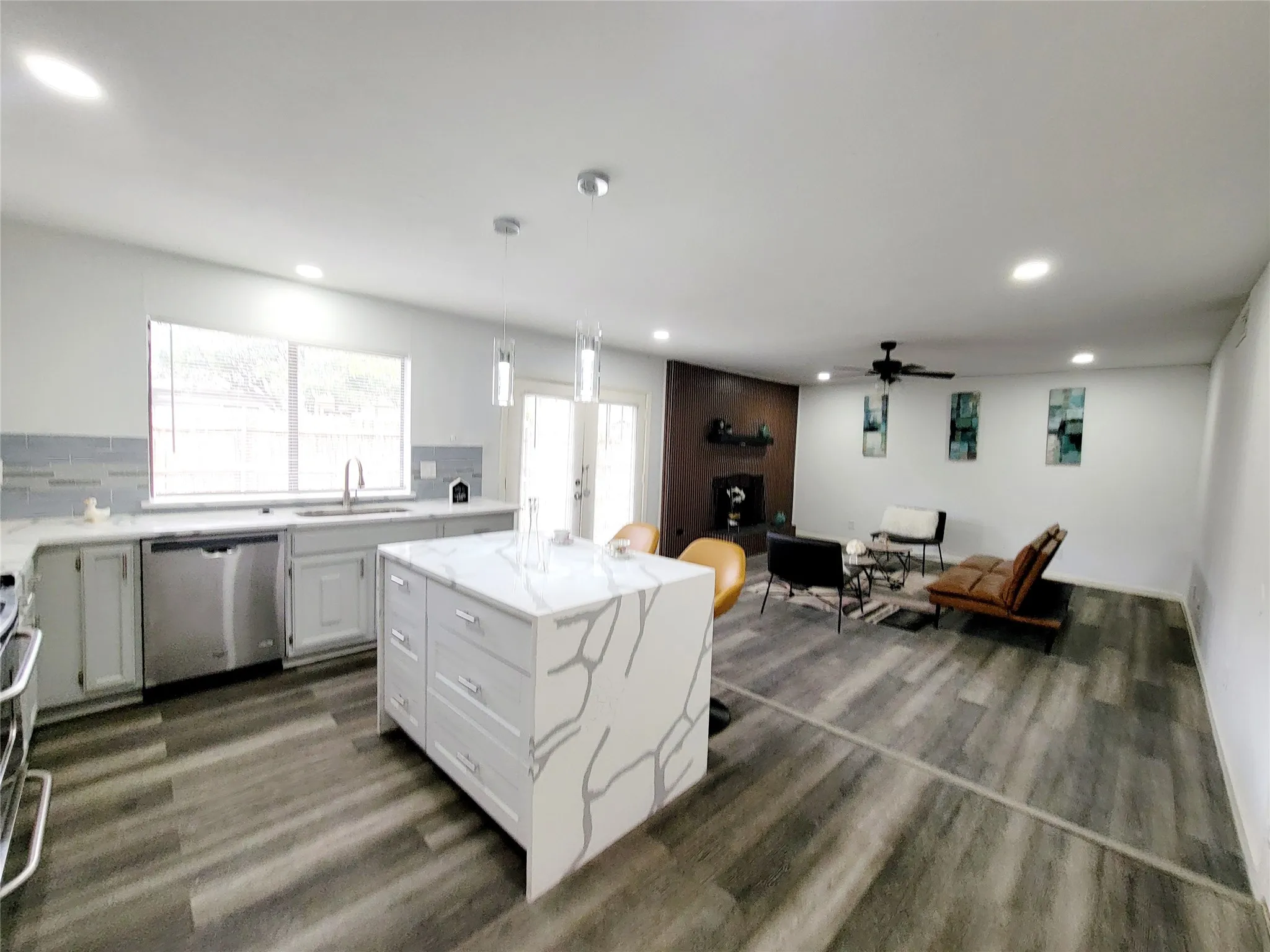 Kitchen featuring dishwasher, ceiling fan, wood finished floors, recessed lighting, and a sink