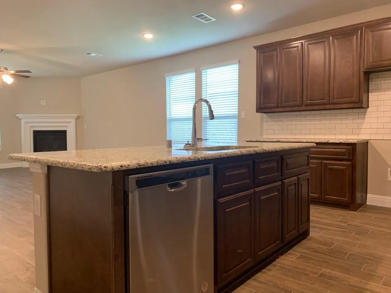 Kitchen island with an undermount sink and stainless steel dishwasher