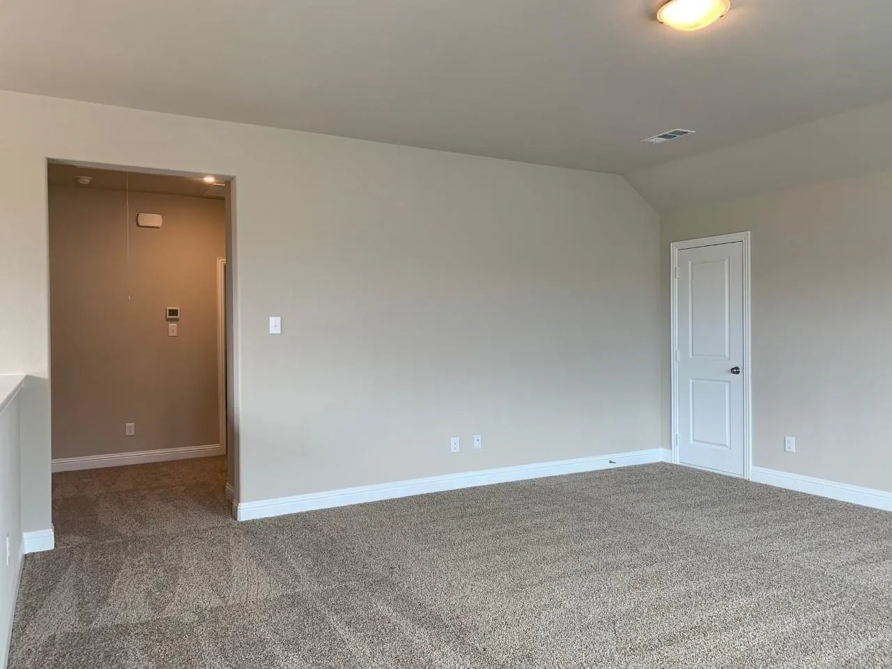 Neutral tone wall paint, carpeted flooring, white trim, recessed lighting, and a flush mount ceiling fixture