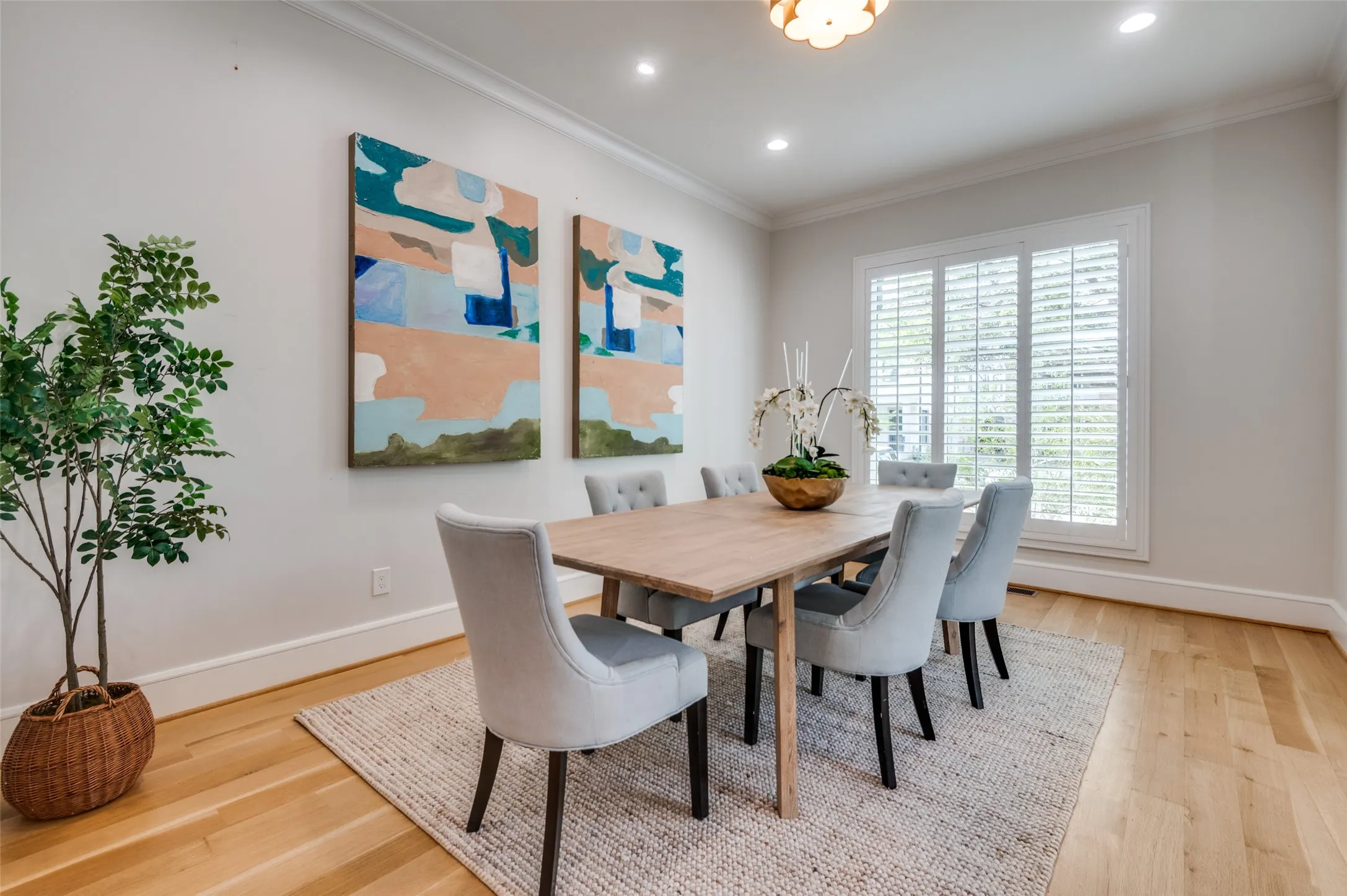 Recessed ceiling lighting, crown molding, wood-finish flooring, and window shutters