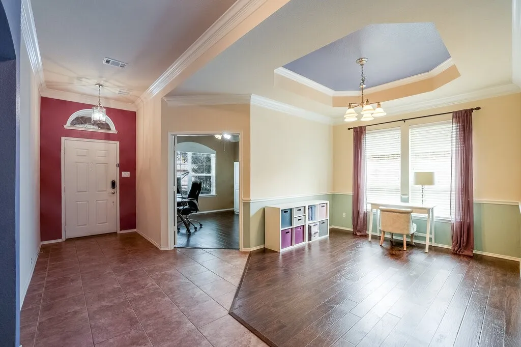 Open the door to large living or formal dining just steps from French doored private study.