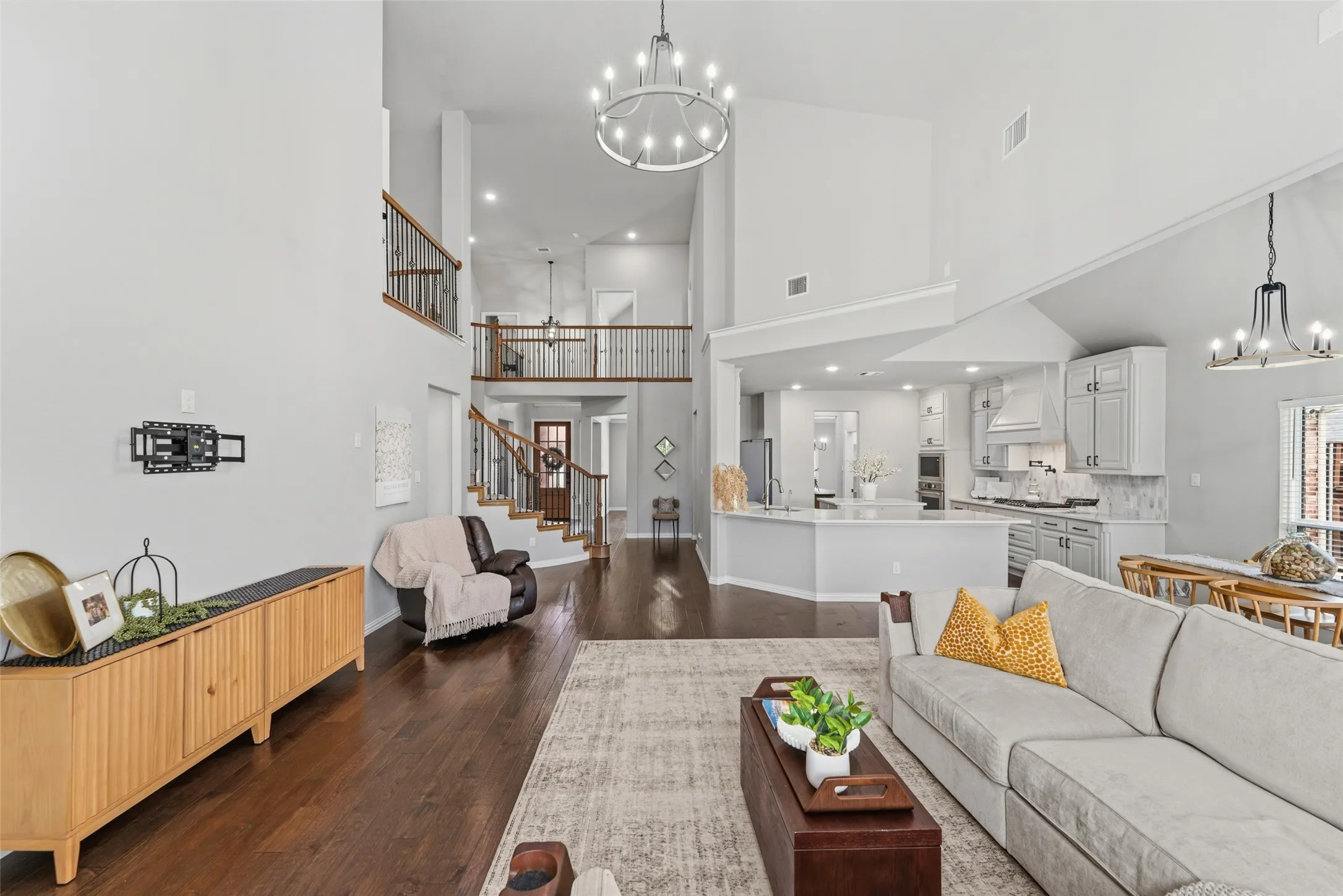 Soaring ceilings, natural light and wood-finish flooring characterize this open-concept interior