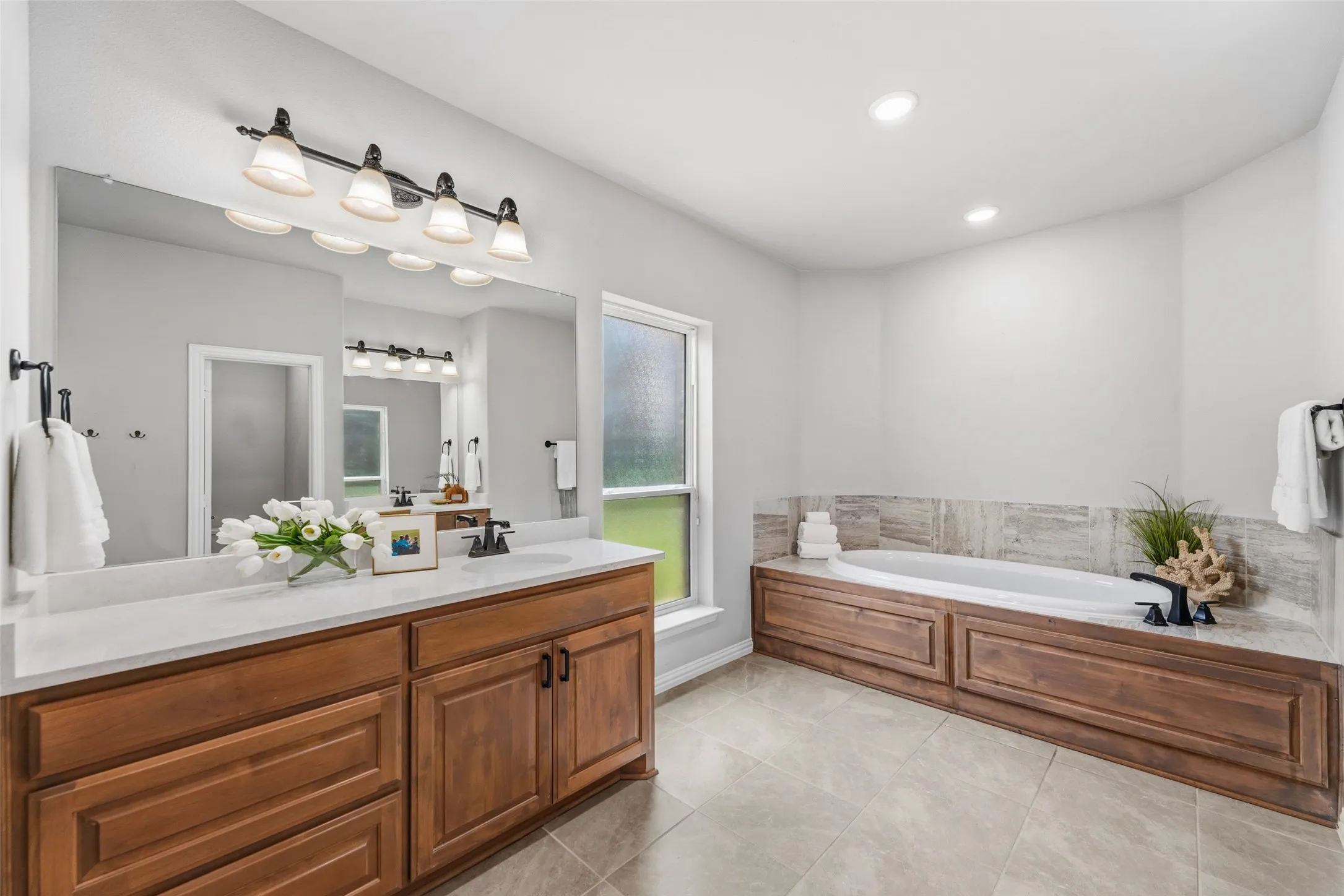 Dual wood-finish vanity with a white countertop and individual sinks