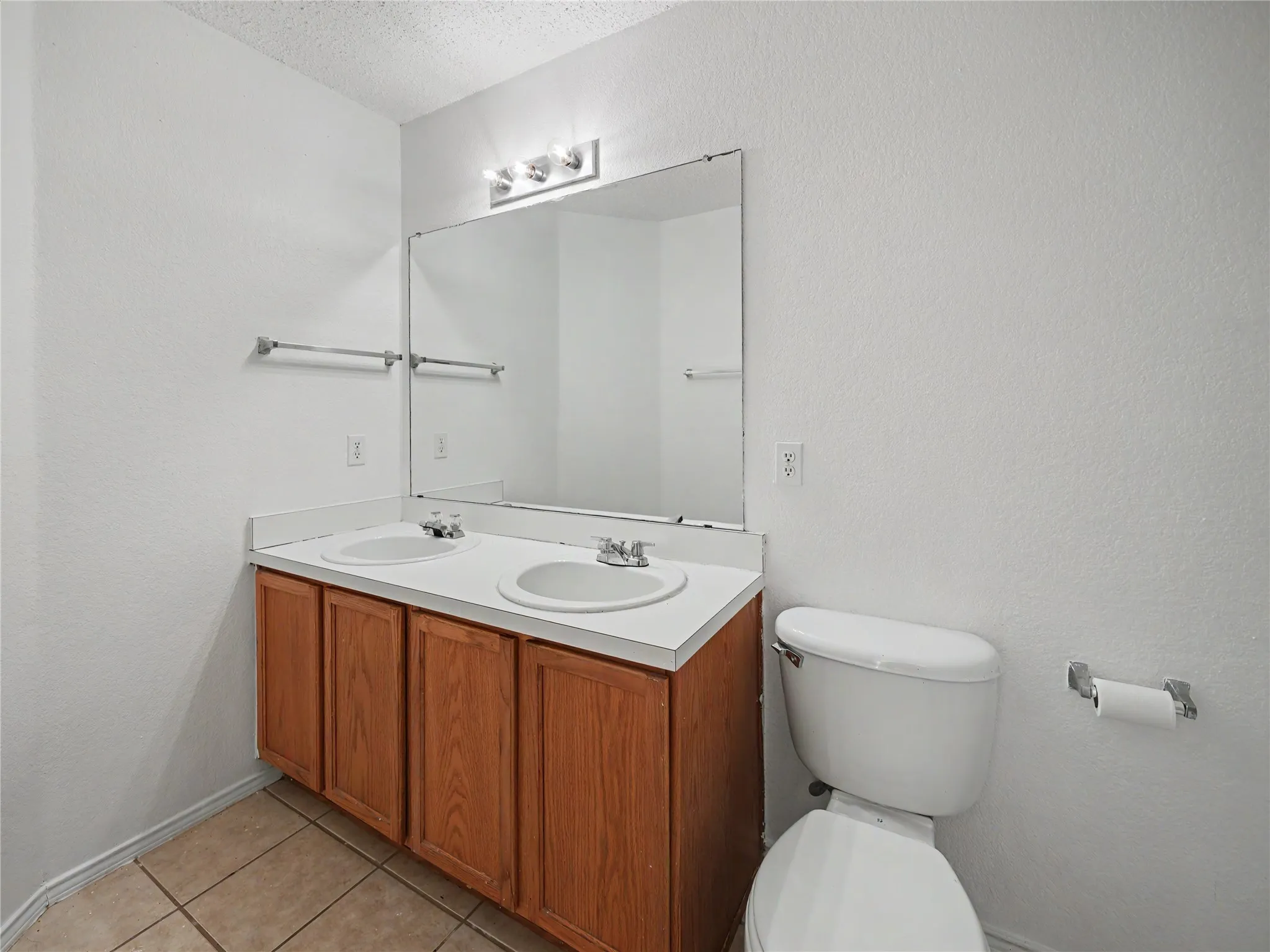 Dual vanity with integrated sinks and wood-finish cabinetry
