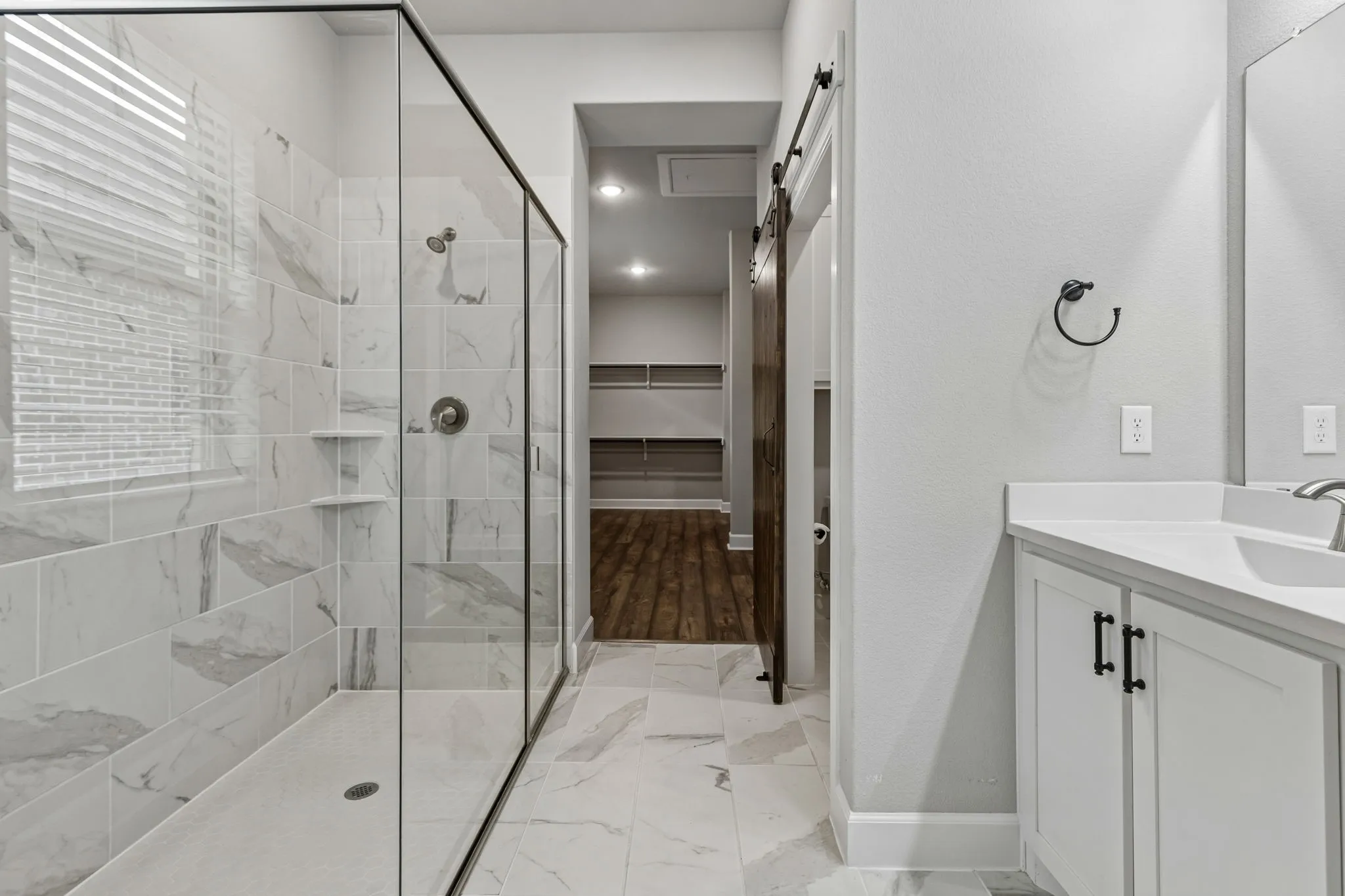 Walk-in shower with full-height tile surround and glass enclosure