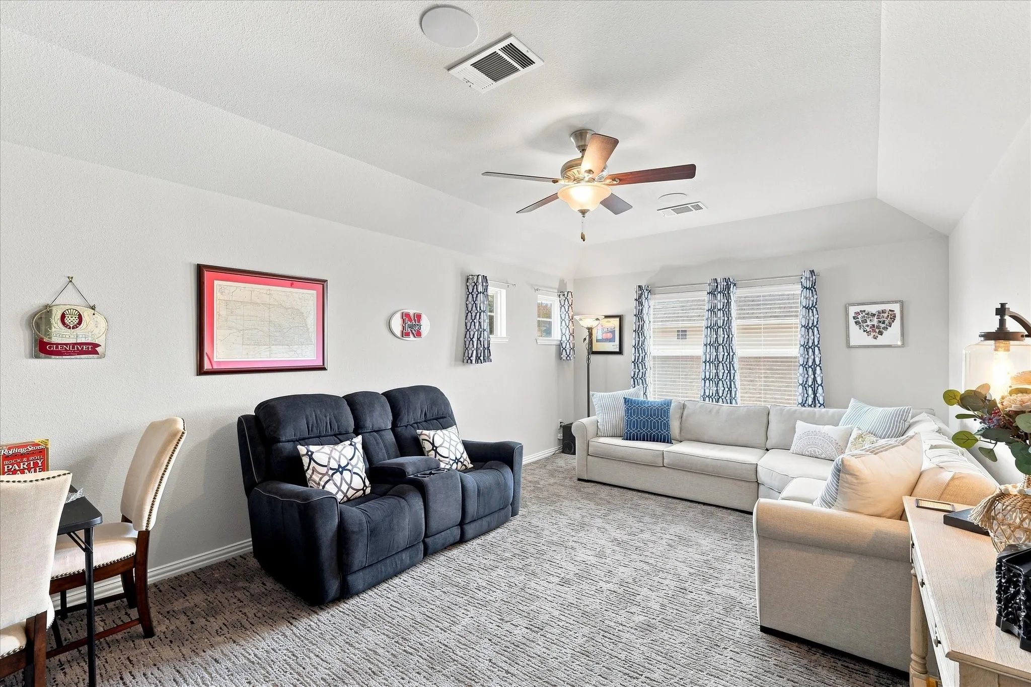 Spacious 2nd-Floor Bonus Room features a Vaulted Ceiling, Lighted Ceiling Fan, Abundant Natural Light. A Generous Open Space Ideal as a Game Room, Media Room or Family Room. A Versatile Retreat Separate from the Main Living Spaces.